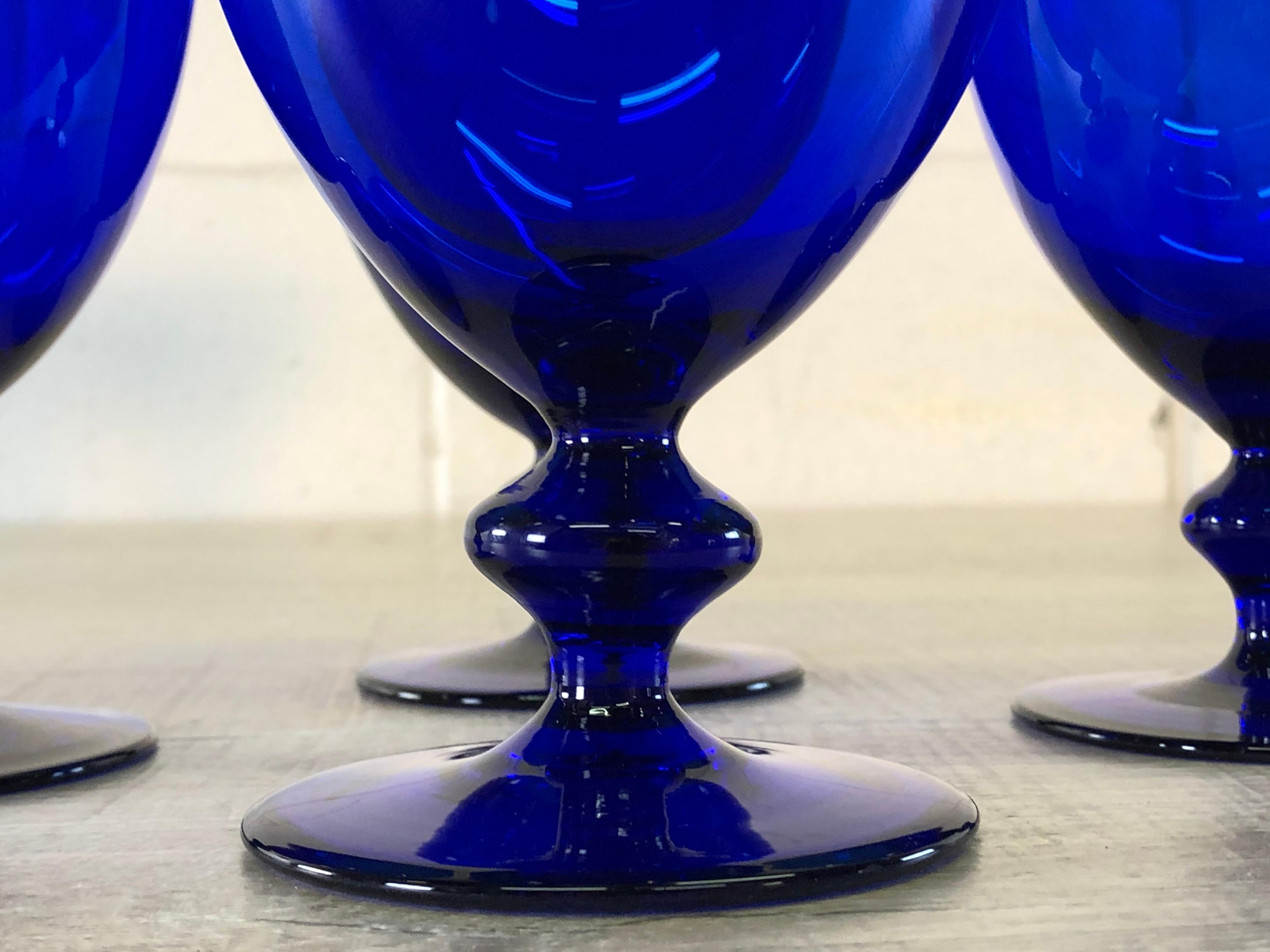Vintage set of four cobalt glass goblets with a ball stem. No marks.
