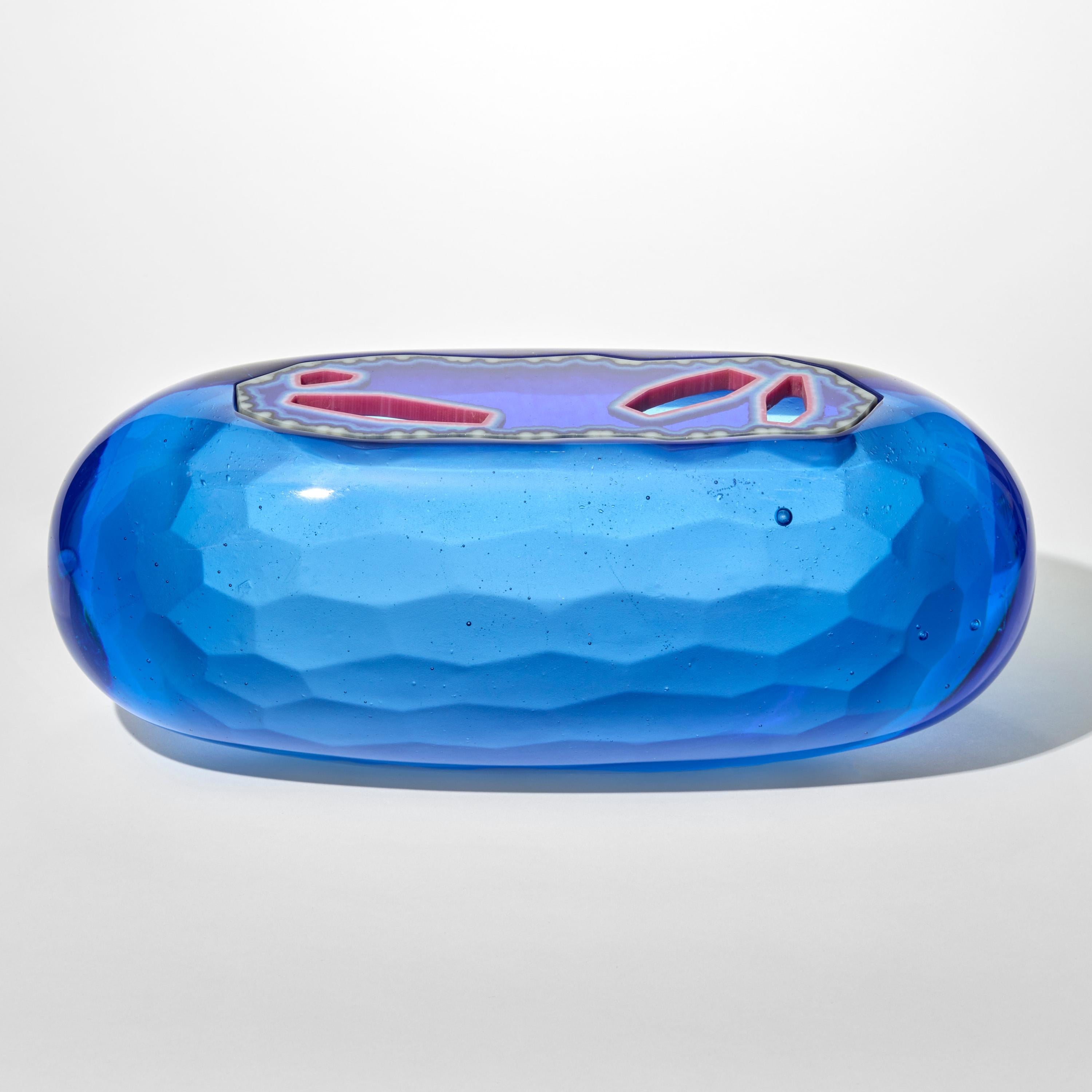 'Cobalt Lozenge Agate Geode' is a unique lost wax cast glass sculptural vessel by the British artist, Angela Jarman.  

Jarman is an artist with over 20 years experience in glass. Technical skill and understanding of her material, combined with a