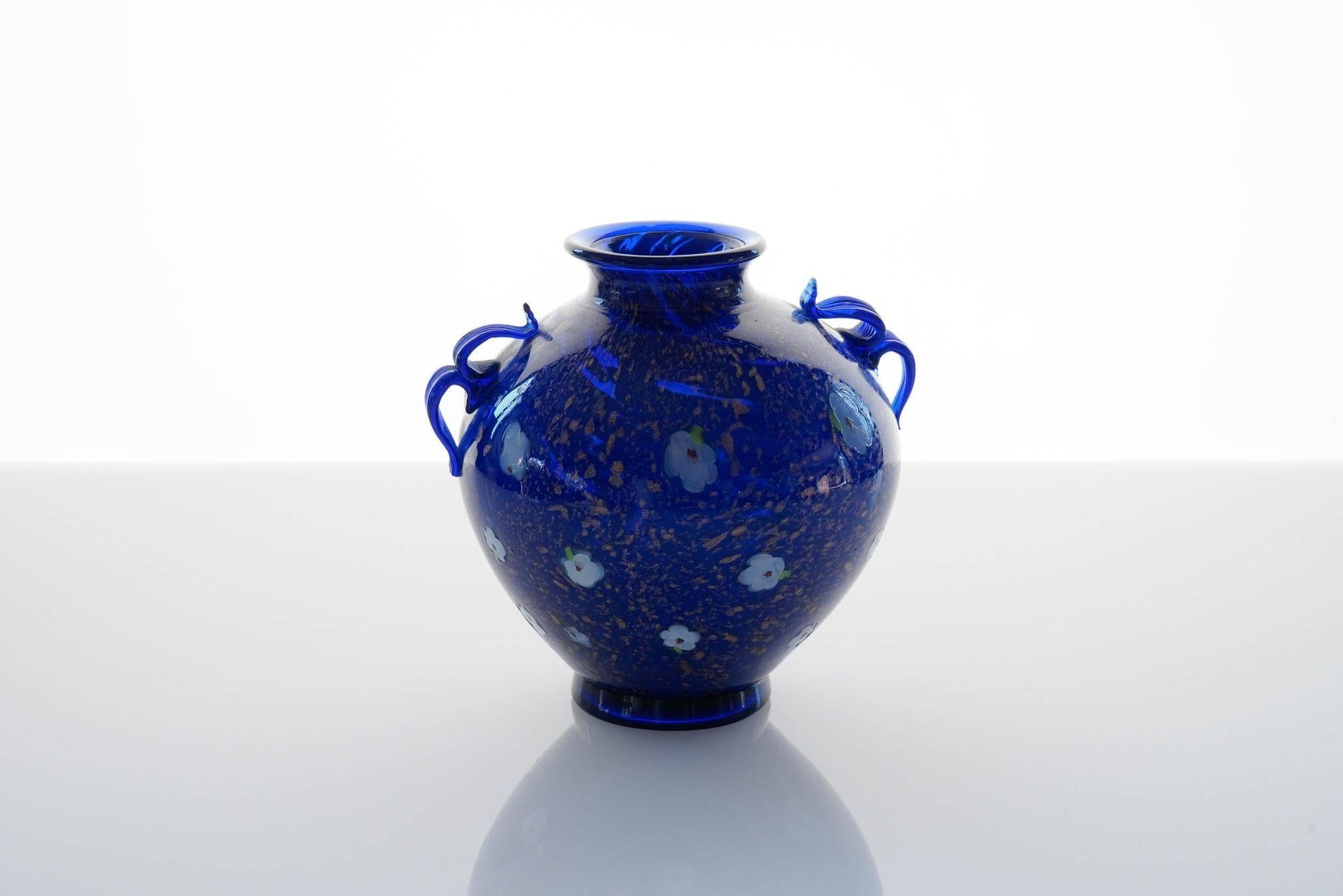 Rare vase in blue cobalt glass from Fratelli Toso.
The finish of the vase is with Avventurina speckling fused over the glass (Tociato in Muranese) to resemble Lapis Lazuli gemstone. Over that the vase has beautiful peach flower murrinas made by