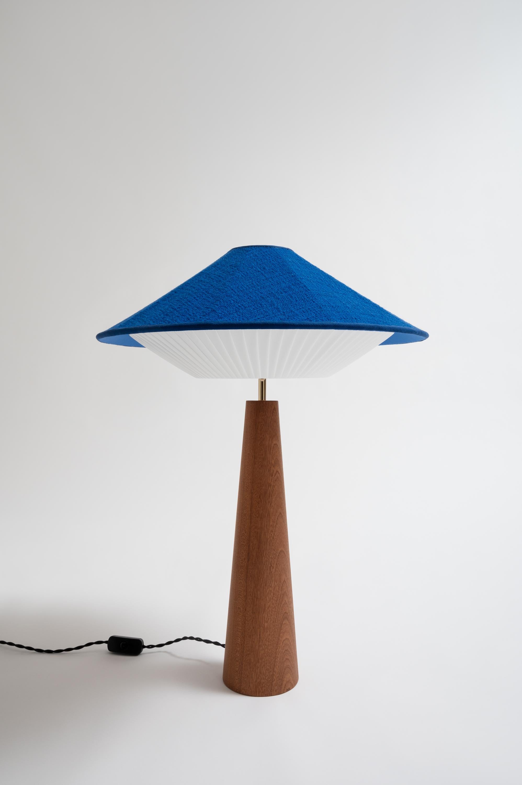 Cobalt Otto Table Lamp by Servomuto
Dimensions: D 50 x H 67 cm
Materials: Upper Lampshade: Rubelli / Dedar fabric. Lower Lampshade: Pleated pongé bends. Structure: Mahogany base and brass-plated iron details.
Weight: 3 Kg. 

Derived from the