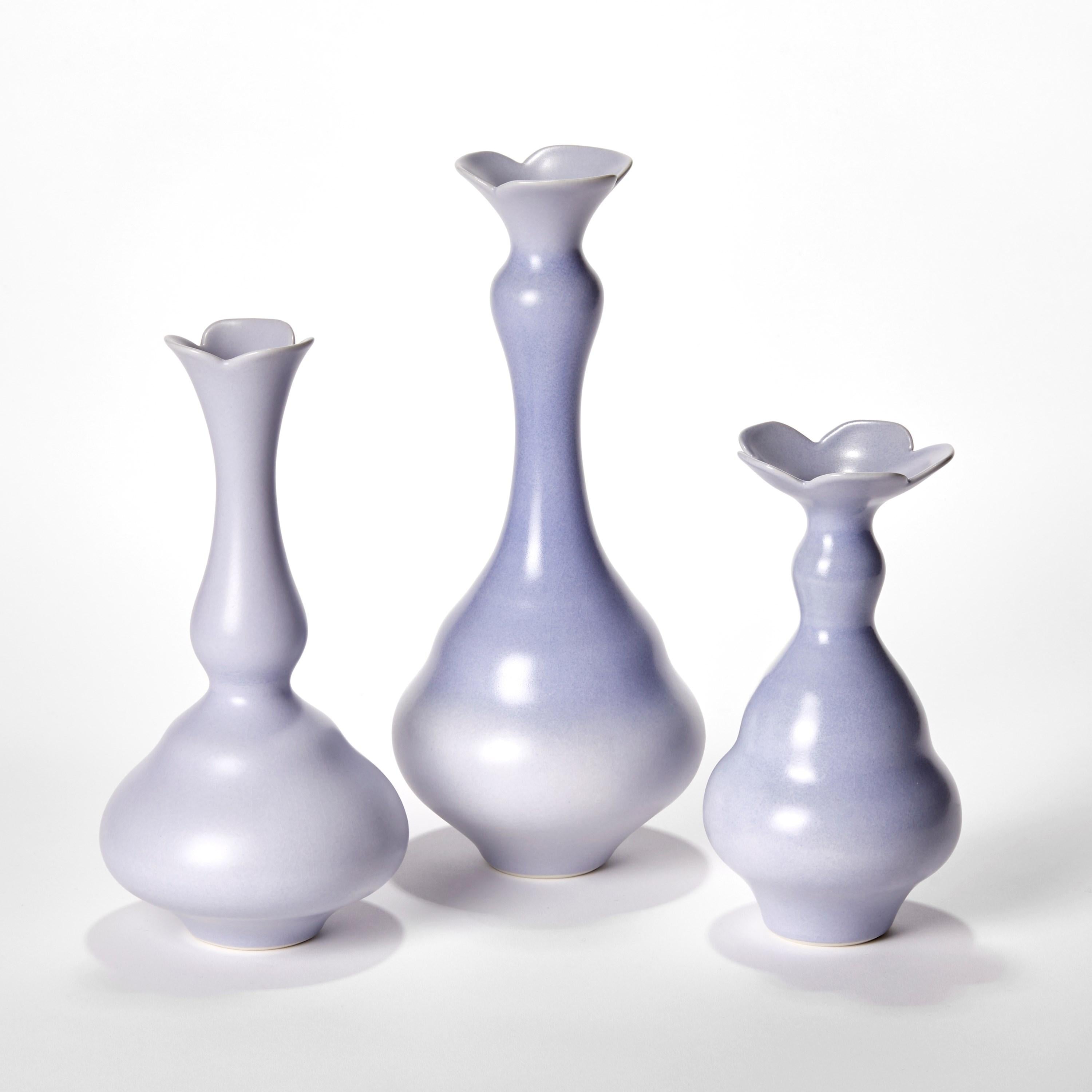 'Cobalt Trio’ is a unique collection of porcelain sculptural vessels by the British artist, Vivienne Foley.

Left to right in the first image:

Cobalt Trilobed Funnel Neck Vase  H 26 cm W 12.5 cm D 12.5 cm
Cobalt Trilobed Shaded Vase  H 31 cm W 13