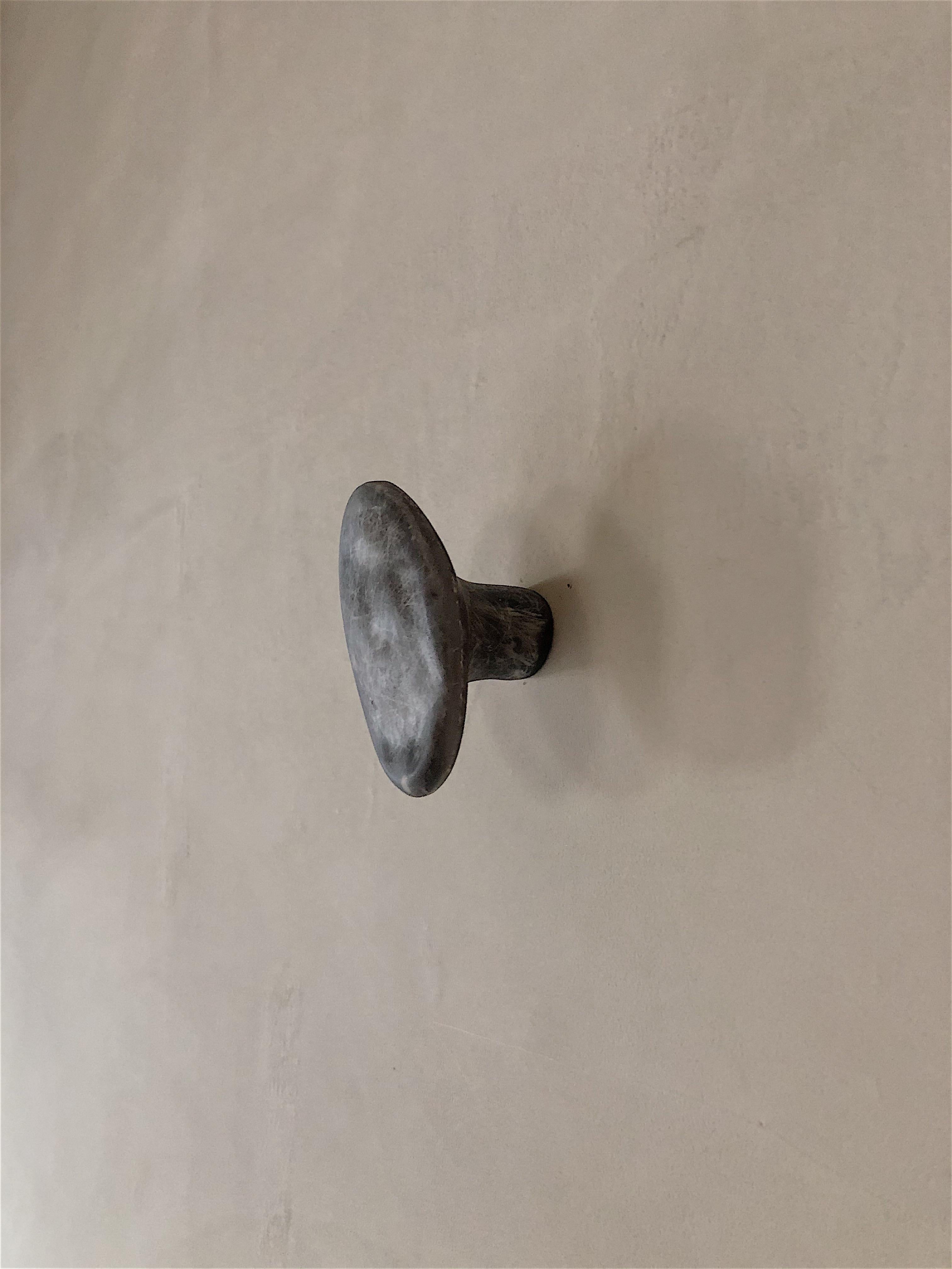 Cobble hook by Karstudio.
Dimensions: W 6 x D 5.5 x H 1 cm.
Materials: FRP.
Other colors available.

Like a jade in the rough, it could be use as a hook or door handle; the hook with irregular lines brings fun to a monotonous line-straight