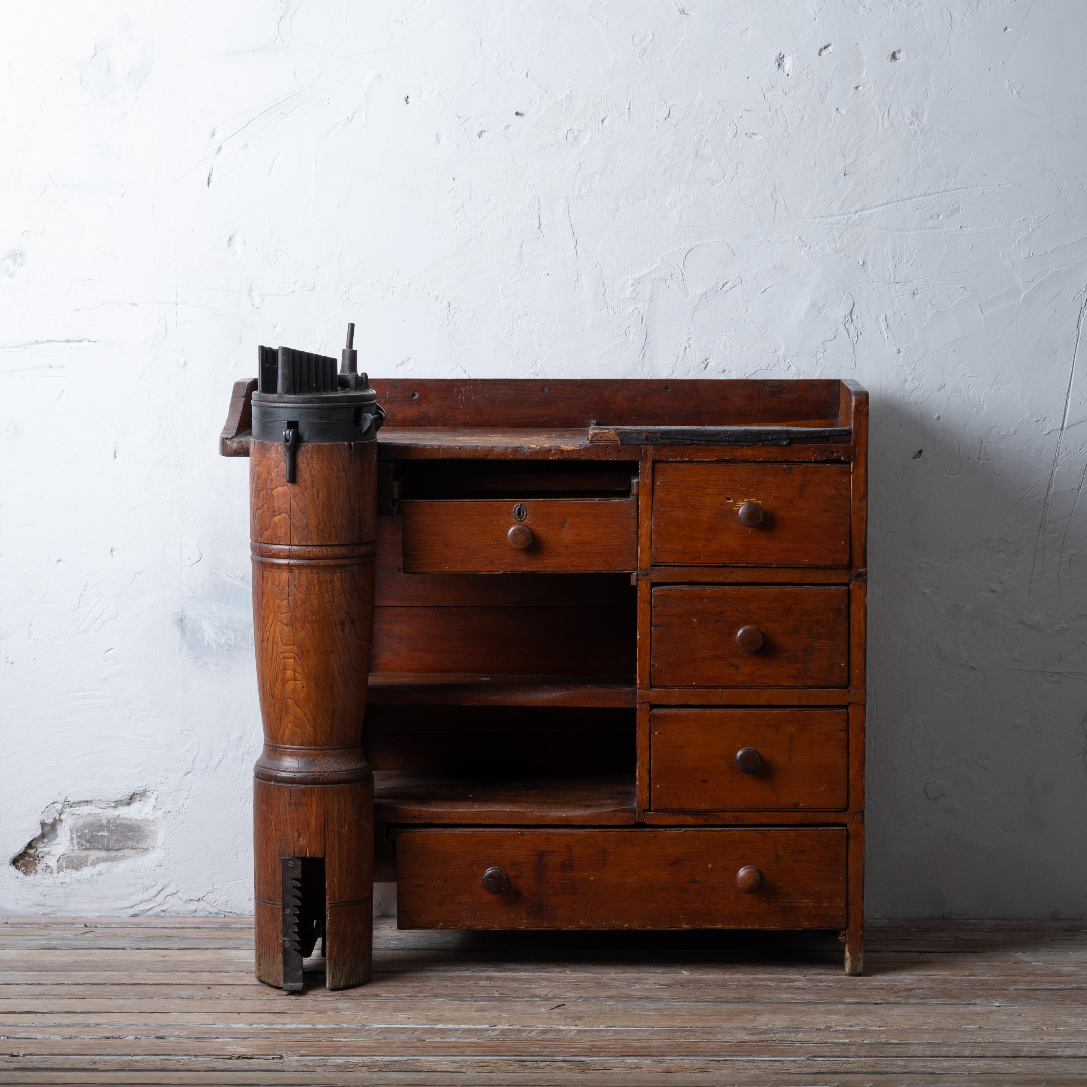 A New England cobbler’s bench, circa 1860s.

Pine and Ash with cast iron T.D. Bailey No. 4 pegging jack, pat’d 1858.

43 inches wide by 22 inches deep by 38 ¾ inches tall

Fair overall with wear.  Jack has breaks and losses. 