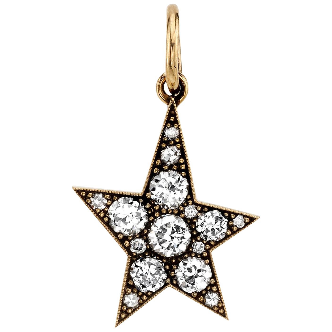 Approximately 0.90ctw varying old cut and round brilliant cut diamonds in a handcrafted 18K yellow gold pendant. Available in an oxidized or polished finish, please specify when ordering. Charm measures 16mm x 23mm.

Price may vary according to