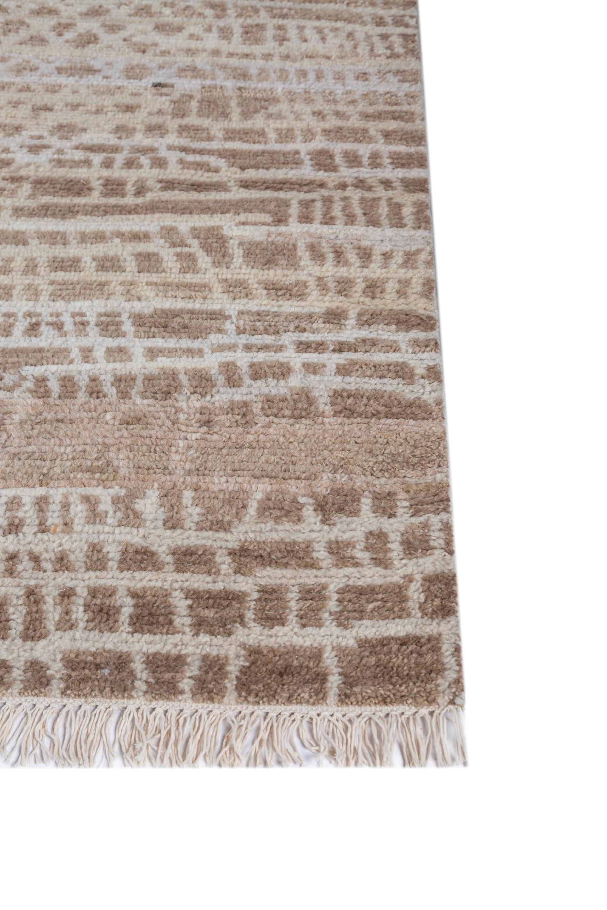 Step into the serene elegance of 'Cobblestone Whispers,' a hand-knotted rug. Much like a stroll on freshly fallen snow, this rug features a ground color of white, with a light peach border resembling the warmth of aged cobblestones. Delicate