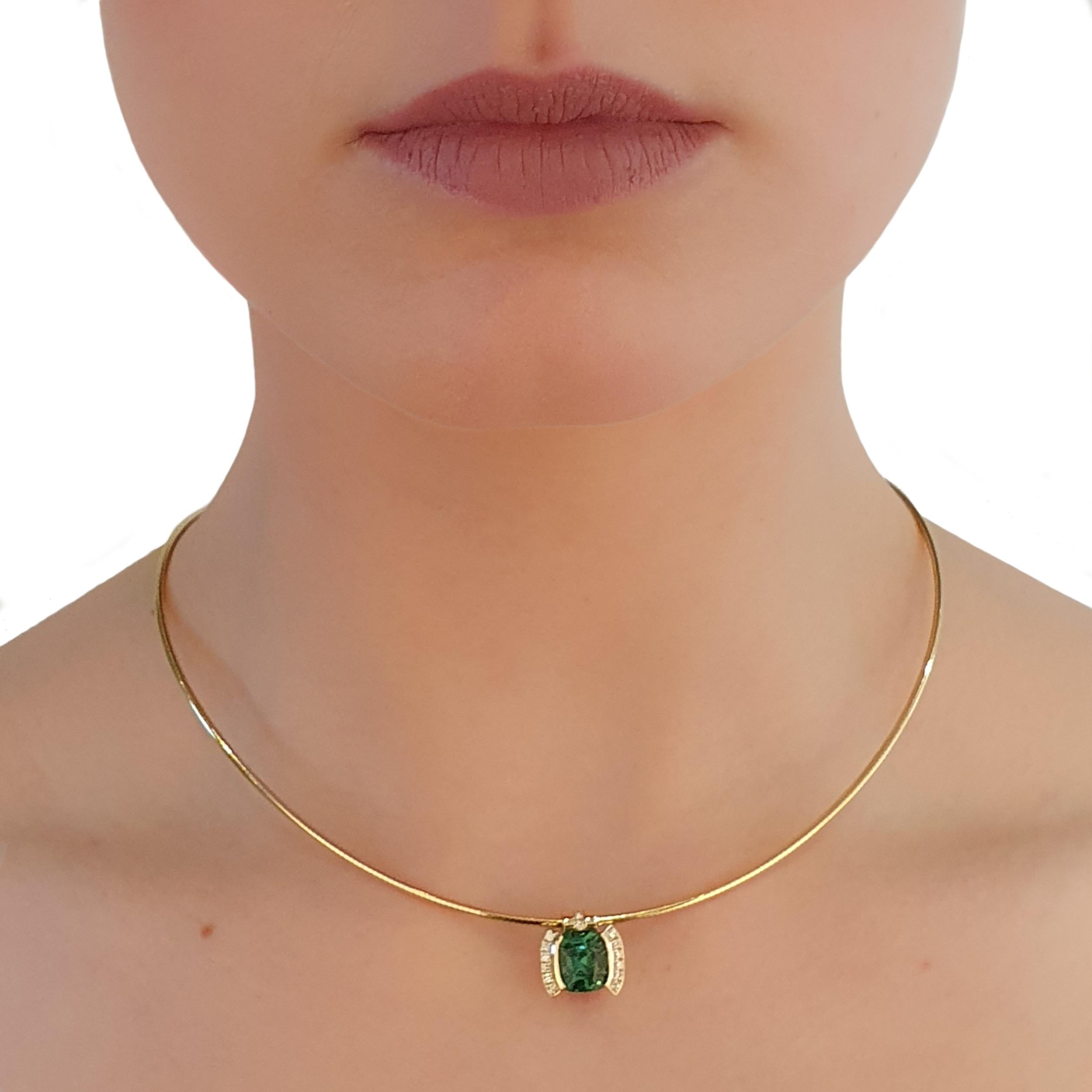 This is a green Tourmaline of magnificent quality, set in a yellow gold pendant of 18K gold. In total, there are also 16 loupe clean Brilliant-cut Diamonds with a total weight of 0,16 ct. in the pendant. 
Please note that the necklace is not