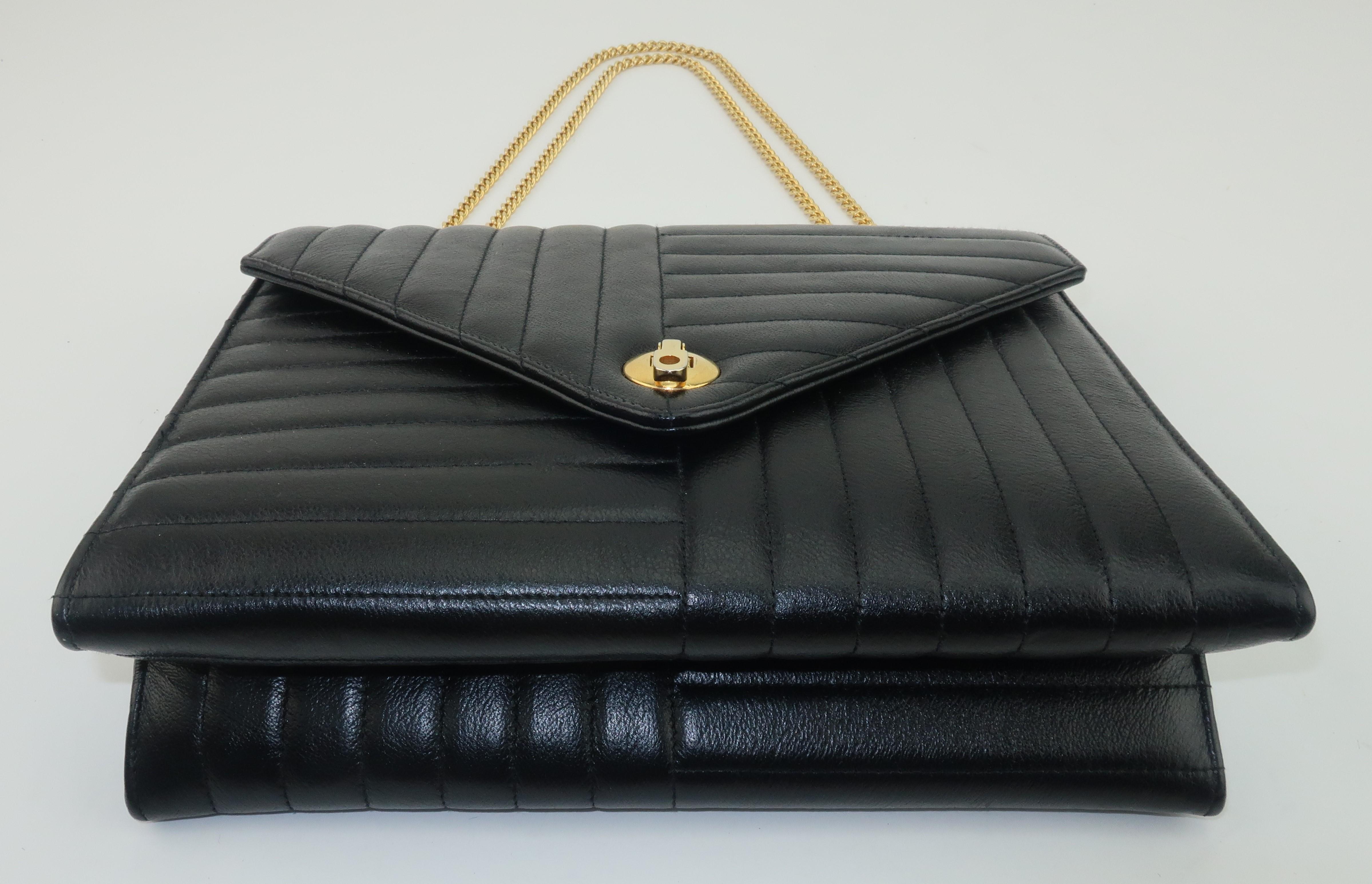 A black leather handbag with a 1960's classicism by Coblentz Originals perfect for a vintage touch to a modern wardrobe.  The body has an envelope style silhouette with a front flap hinged closure and a subtle channeled design that gives a nod to