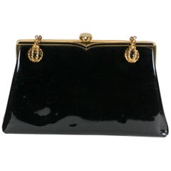 Pochette in vernice Coblentz con charms a forma di sfere di vetro