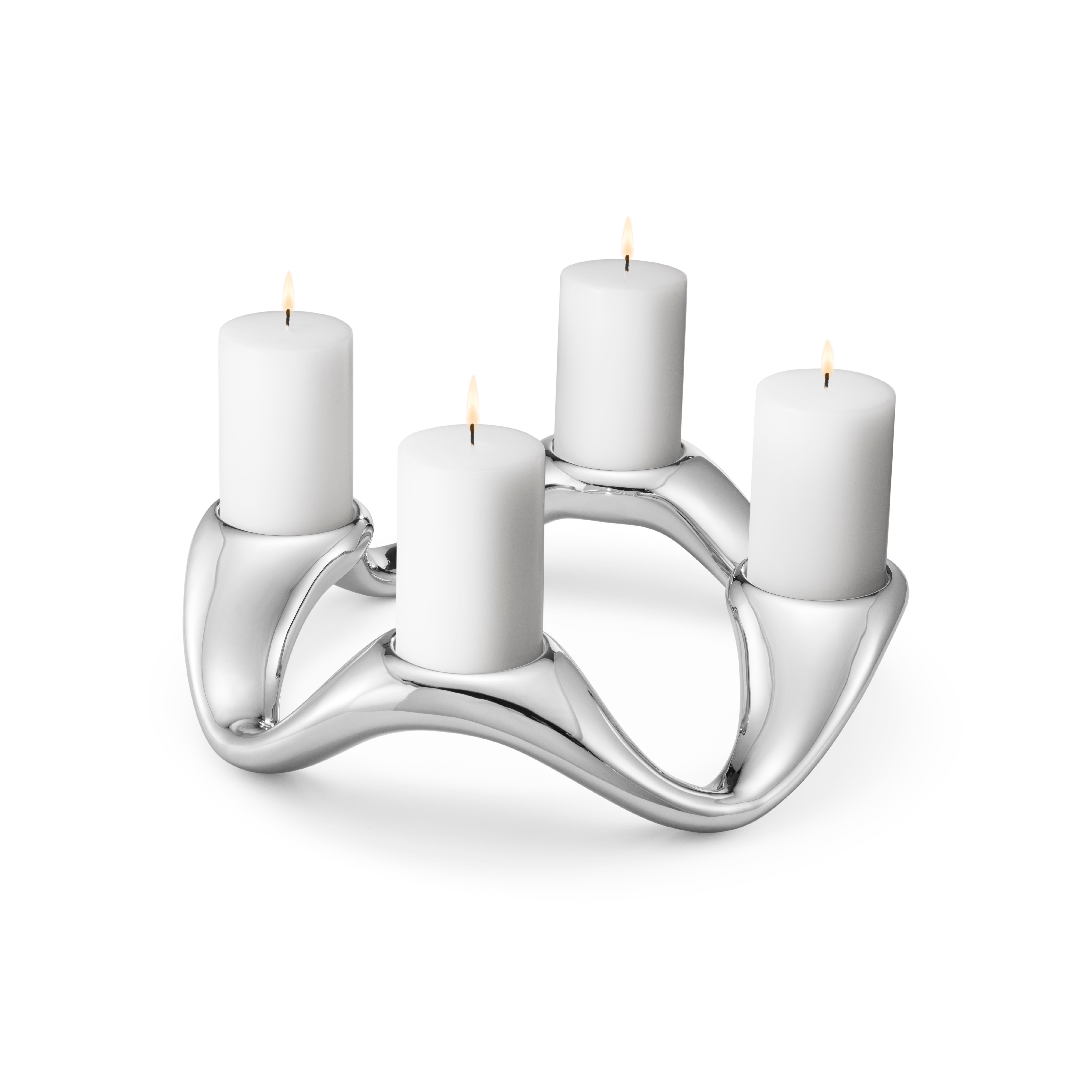 Truly capturing a sense of fluidity and movement, this sculptural stainless steel candle holder makes a striking centrepiece to a table, especially when the candlelight is reflected back on the undulating shiny surface. Holding four pillar candles,