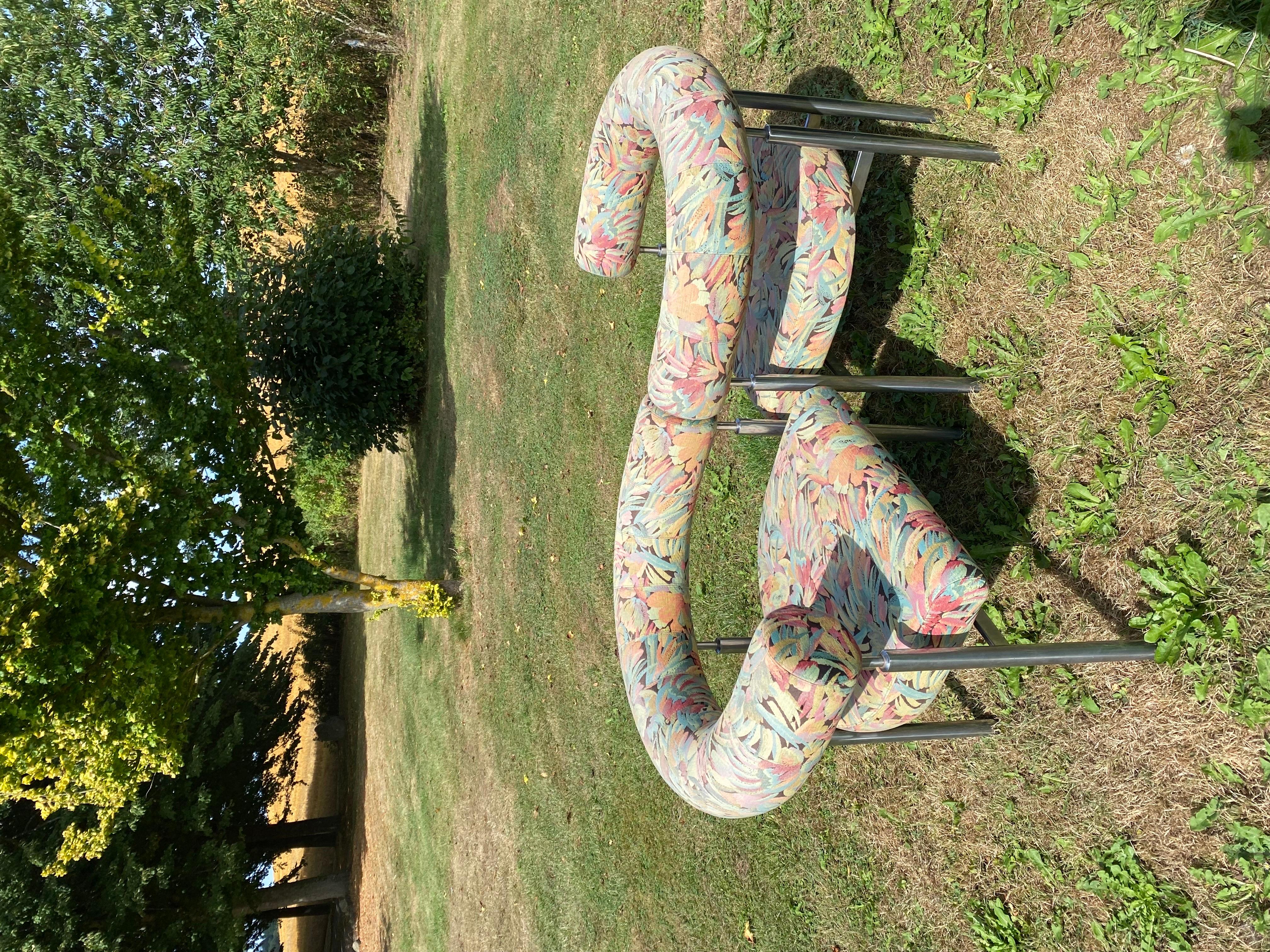 This lovely set of Cobra chairs in in a good vintage condition, original upholstery with fabric of the danish designer Ole Kortzau and frame made of steel. With wear consistent with age and use. A rarely seen set and a true icon of Post-Modern