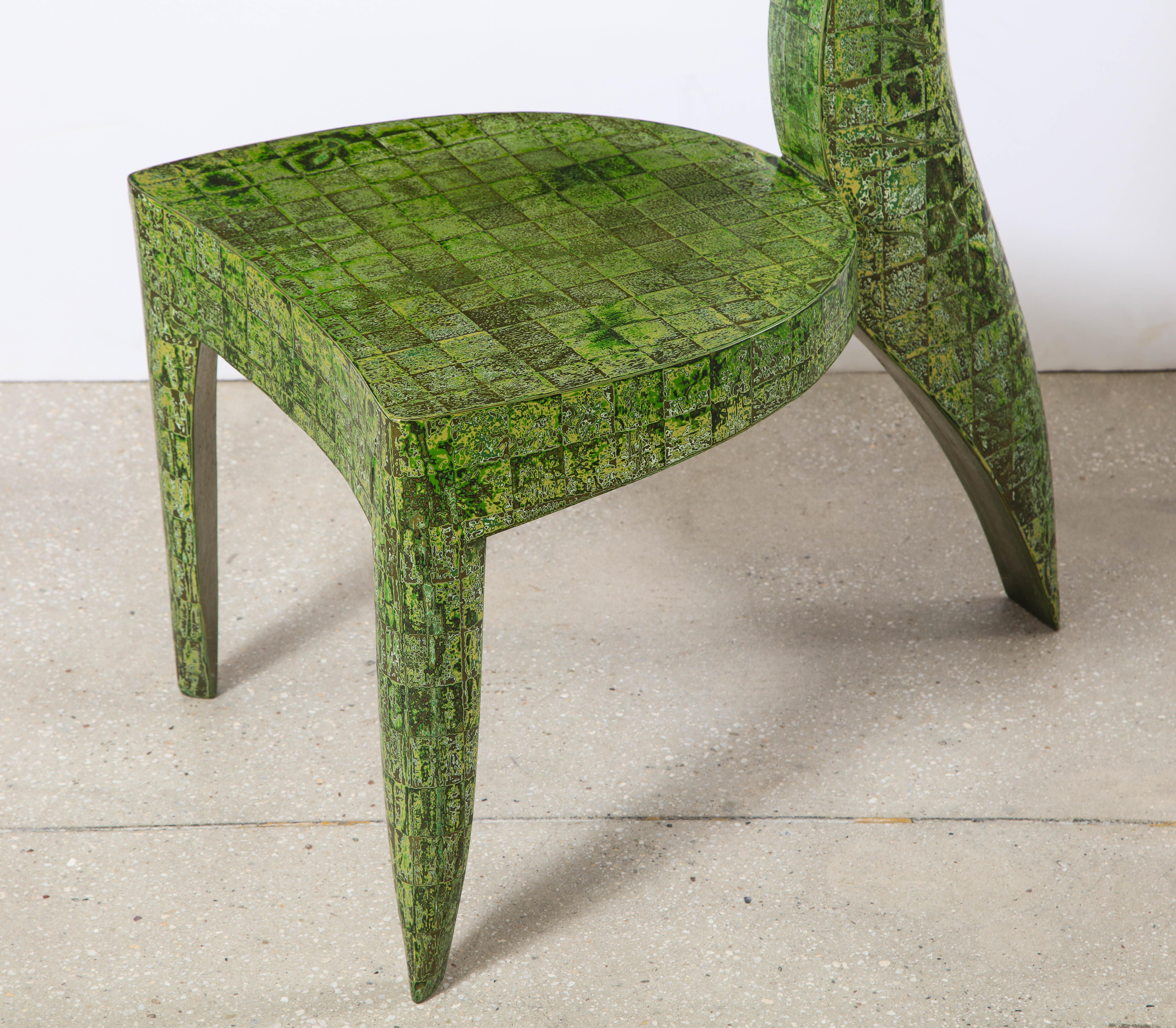 A unique Art Deco inspired chair by the renowned artist Alasdair Cooke, it features the artist's exceptional and quite elaborate art of lacquer and patina. Cooke considers each of his works to be sculpture more than he sees them as furniture.
  