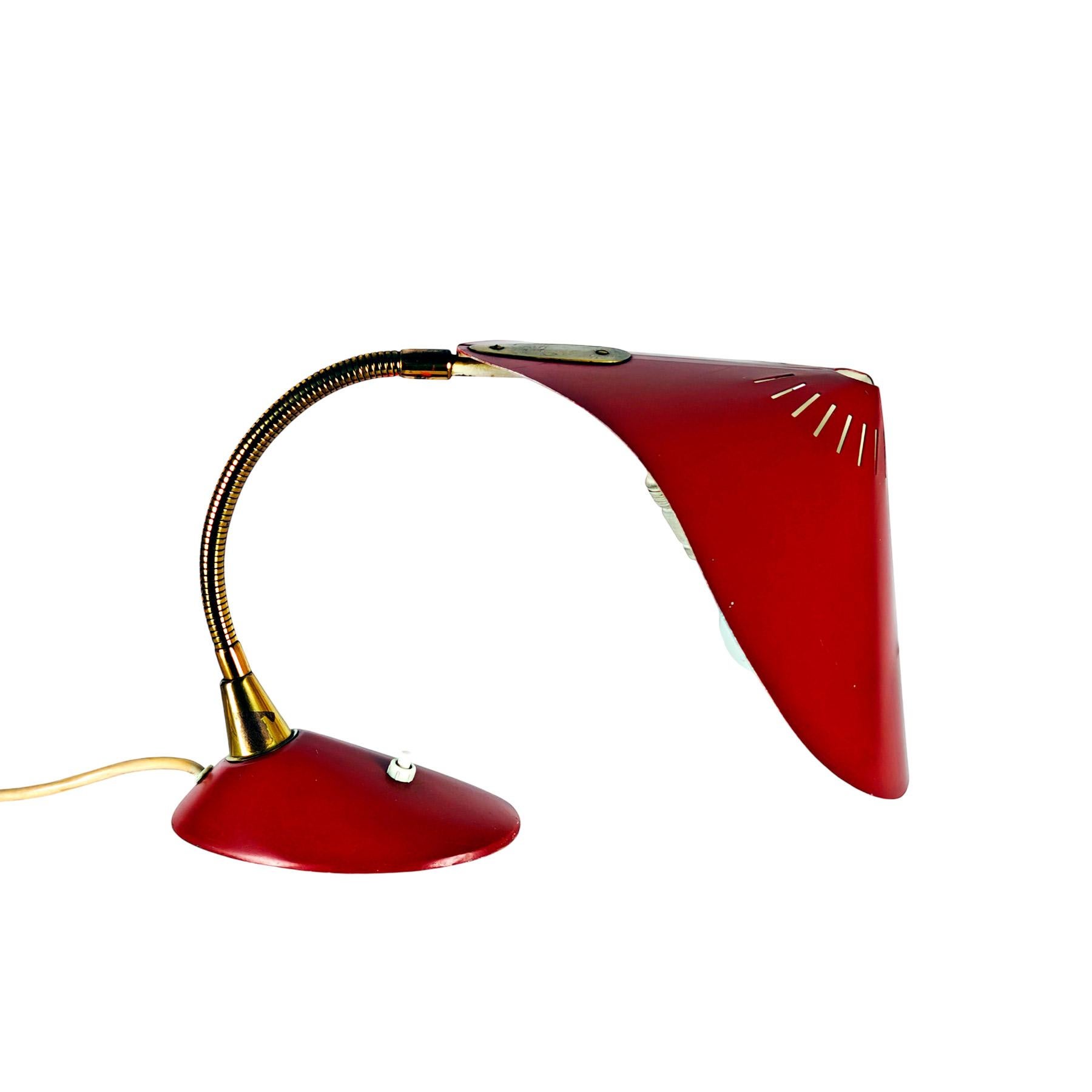 Fully adjustable desk lamp, coral lacquered sheet metal and brass.

Model “Cobra” by the Cosack brothers.

Germany 1955.