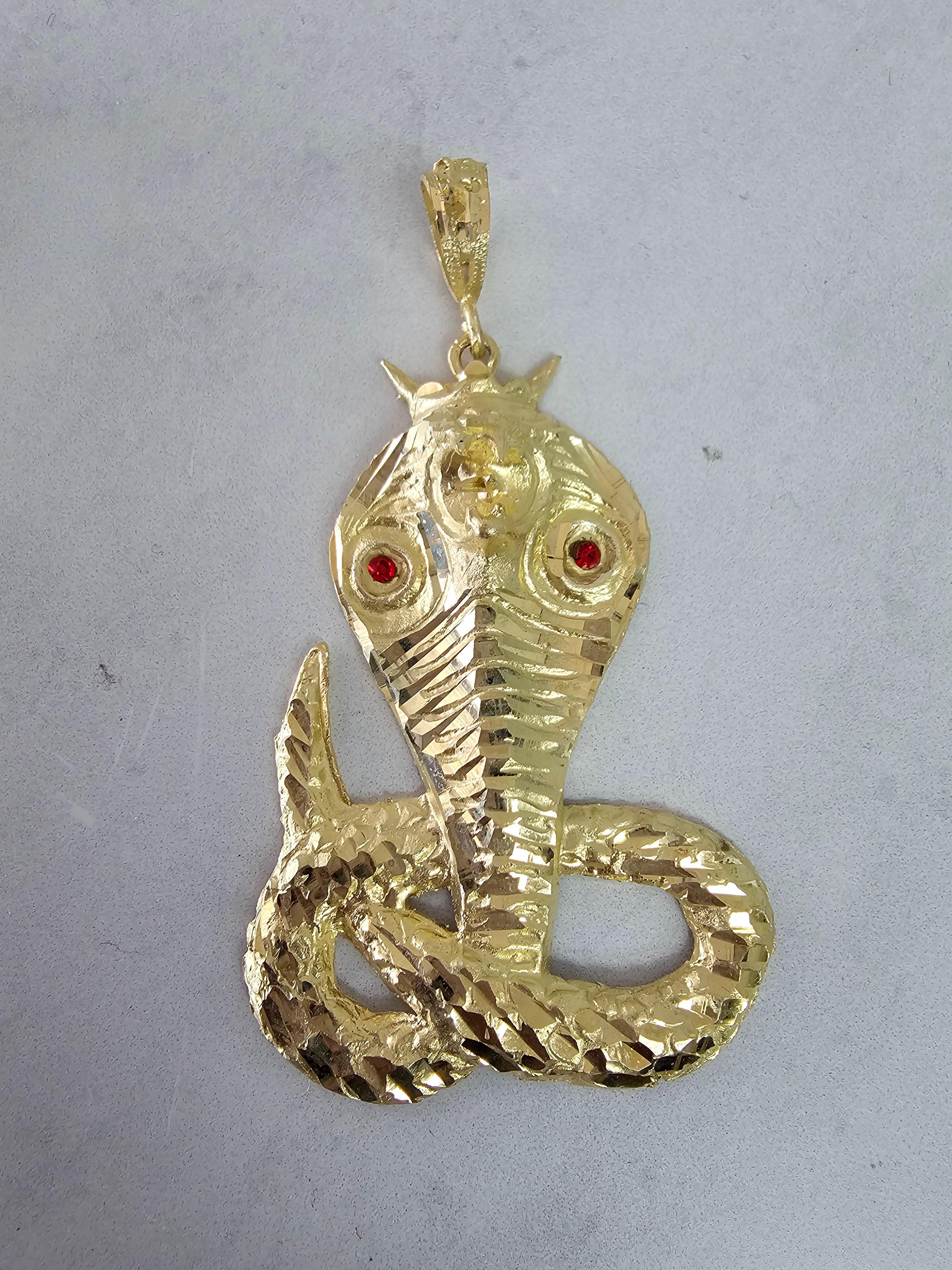 ♥ Product Summary ♥

Details: Cobra with Ruby Eyes with Diamond Cuts
Metal: 10K Yellow Gold
Dimensions: 74mm x 41mm
Weight: 13 grams