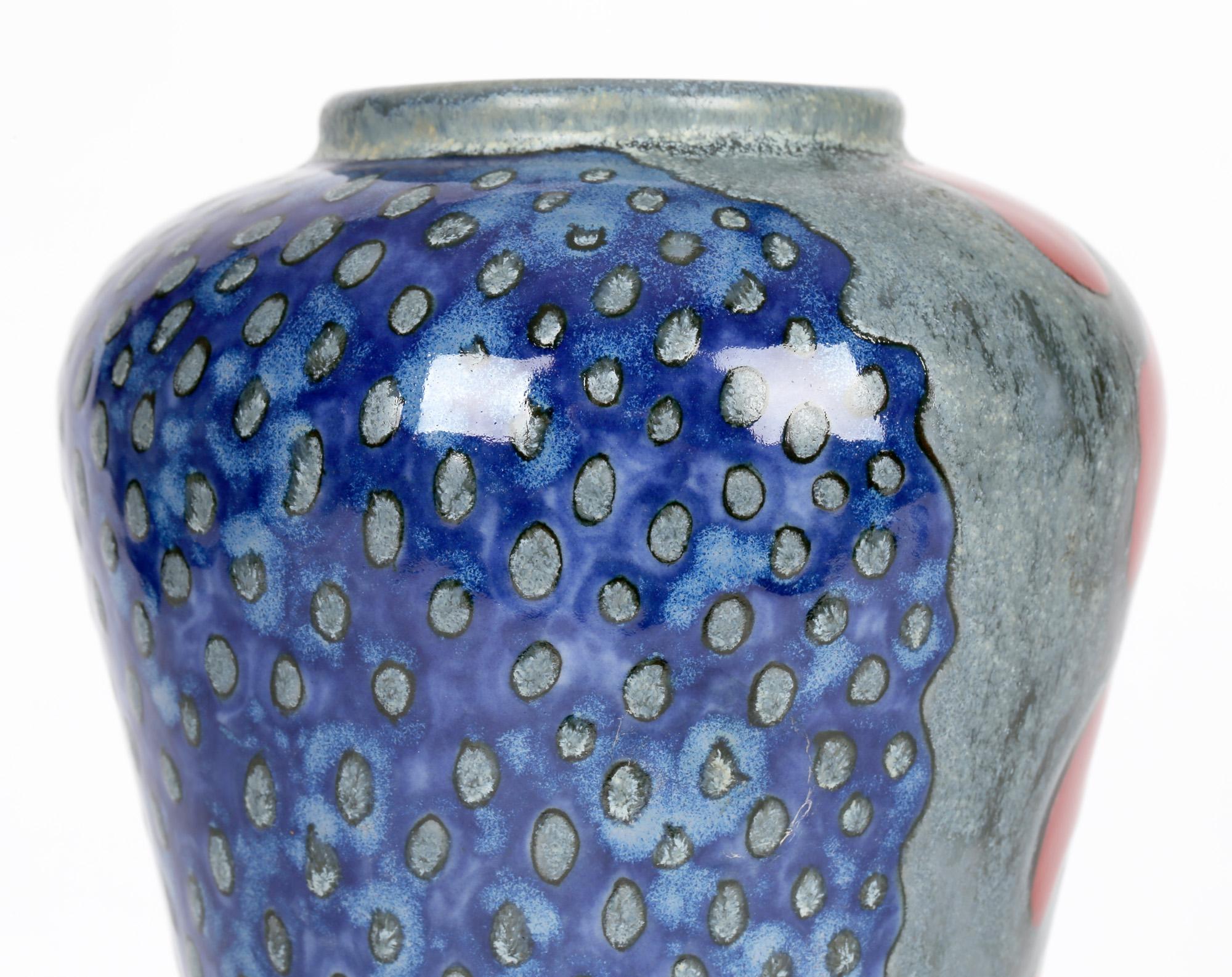 A striking Cobridge stoneware art pottery vase decorated with abstract designs, signed to base and dated 24th August 1999. The vase is of tall elegant shape standing on a skirted rounded base with a narrow lower body widening towards the top with a