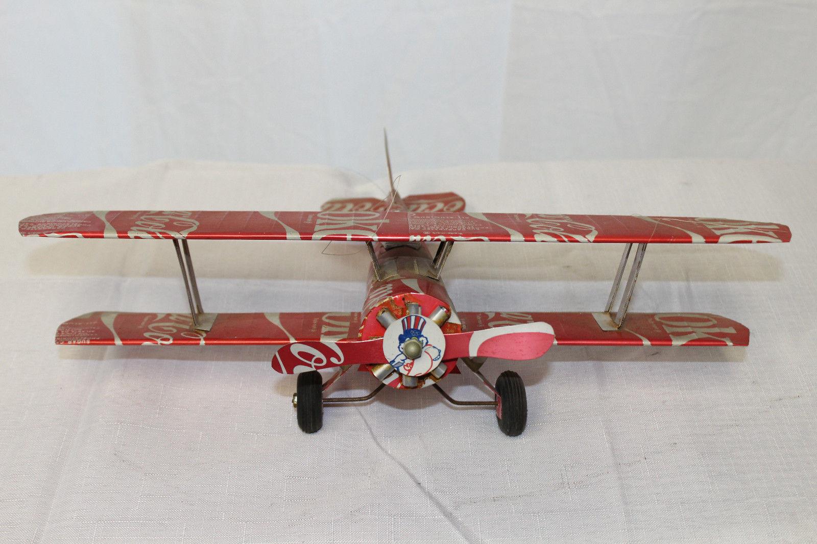 Awesome bi plane that's a custom handmade piece made out of Coca-Cola cans.