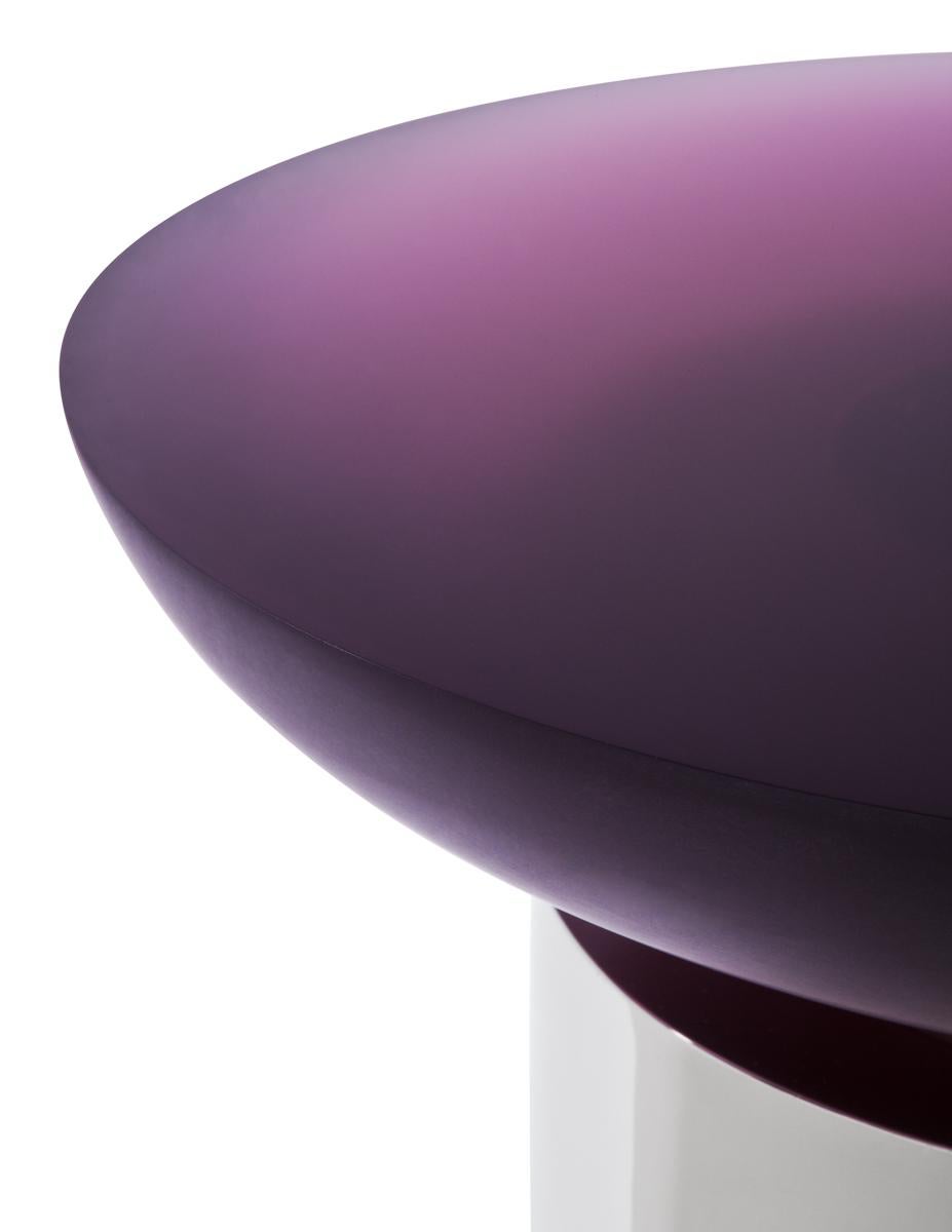 Polished and etched resin table top supported on a cylindrical metal base.
Resin top available in nine colors: Amber, amethyst, ash, aquamarine, jet, rose quartz, ruby, sapphire, topaz.

Shown with an Amethyst resin tabletop and polished nickel