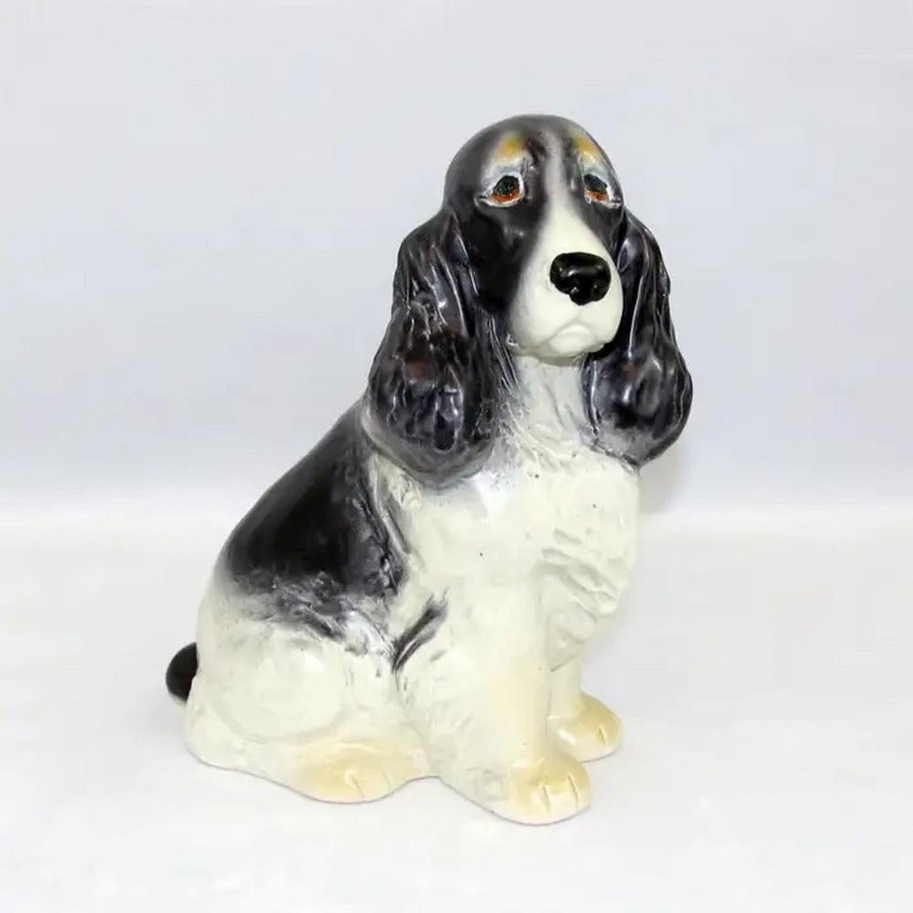 Charming ceramic figurine of a cocker spaniel. It has a very realistic look and a priceless eye expression. Very beautiful! Good overall condition, with normal wear, no damages, and some fading. Manufacturer's original label on it and stamped to the