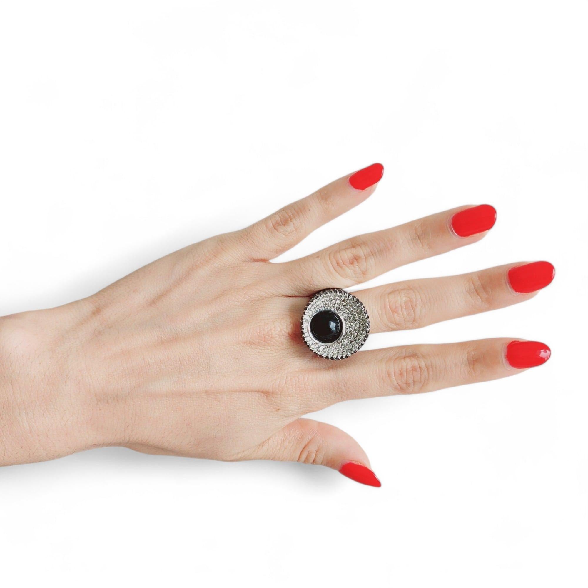 Elevate your style to new heights with this mesmerizing cocktail ring crafted in 18k white gold. A true statement piece, this ring exudes sophistication and allure, drawing inspiration from both classic and contemporary design elements.

At the