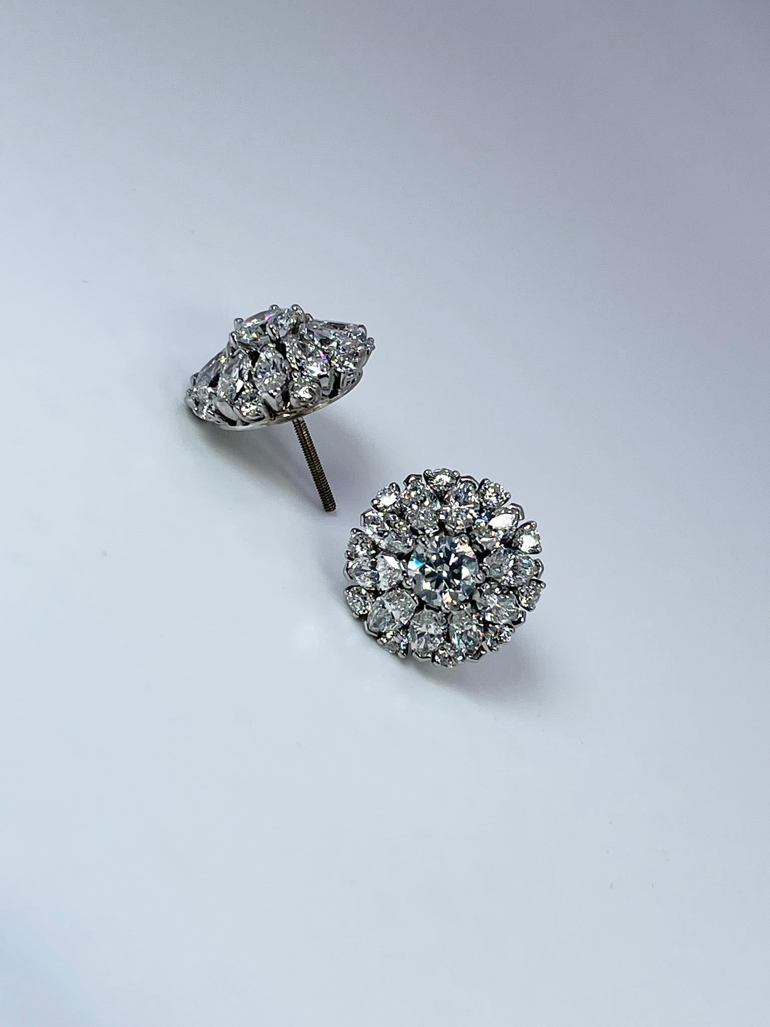 Luxurious cocktail diamonds earrings made with 6.30 carats of diamonds. The center two diamonds are weighing 1.75 carats. These earrings are 0.61 inches in diameter.

CENTER STONE: NATURAL DIAMONDS
CARAT: 1.75CT
CLARITY: VVS-VS
COLOR: E-F
CUT: ROUND
