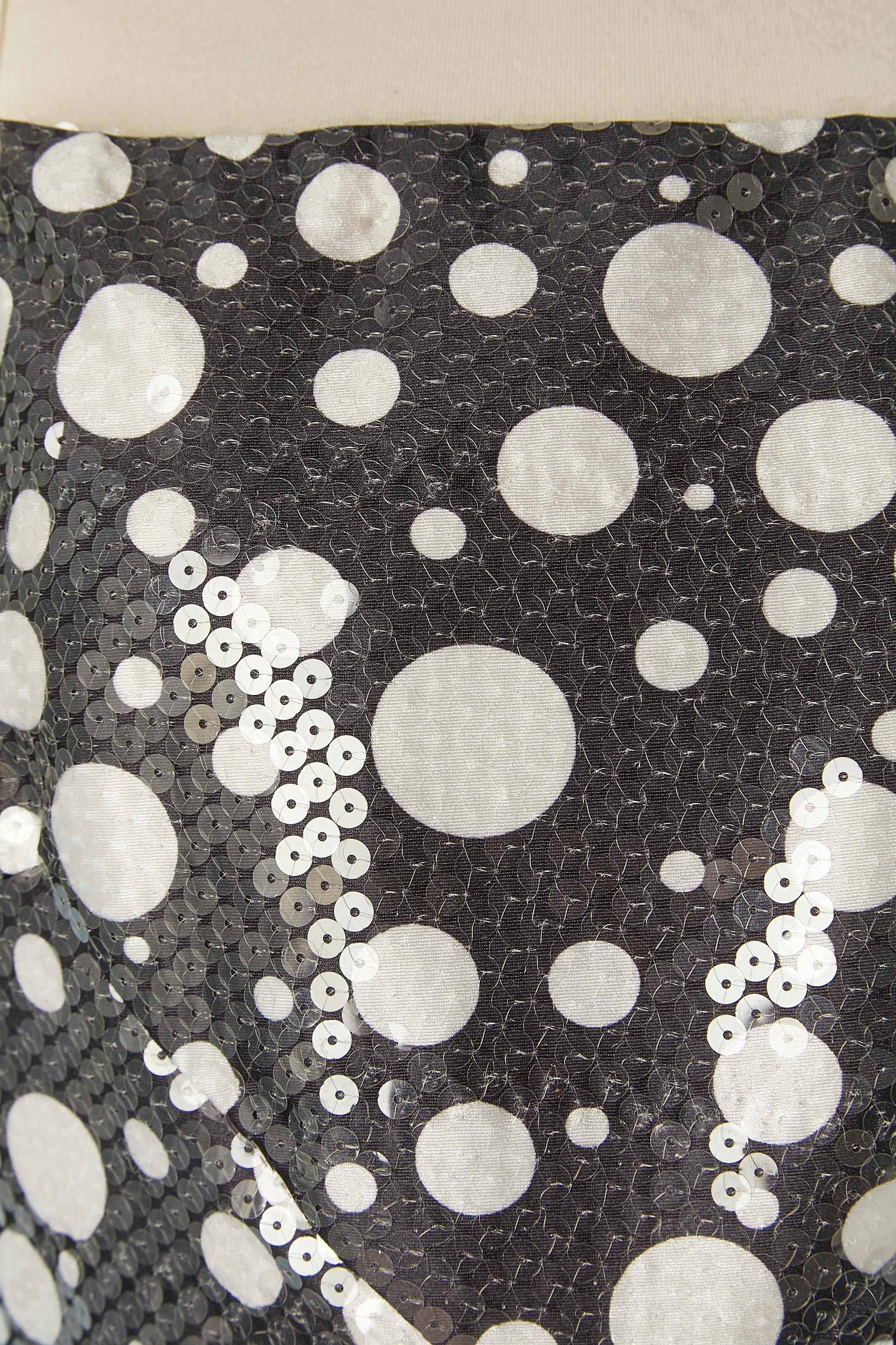 Black cocktail dress with white Polka dots and transparent sequin. No fabric tag composition but the main fabric is probably rayon, acetate lining and tulle petticoat. 
Boned. Zip and hook&eye in the middle back. Black satin ribbon bow in the middle
