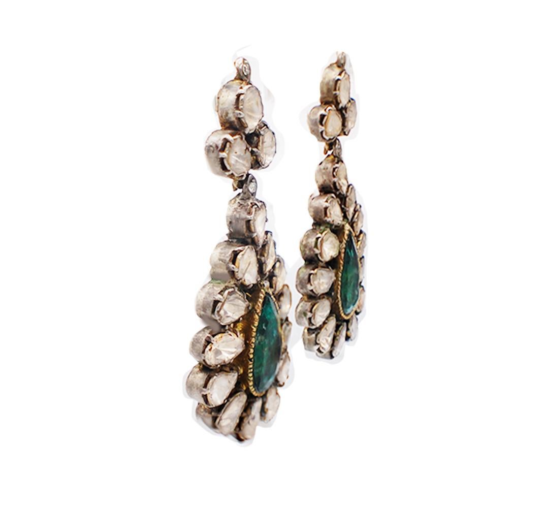 Antique earrings consist of (32) diamond slice uncut shaped surround magnificent green pear shaped emeralds. 


The emeralds are measured as 15.43-8.42 and have a total weight of an estimated 9.00 carats. 
The color green is bright and are