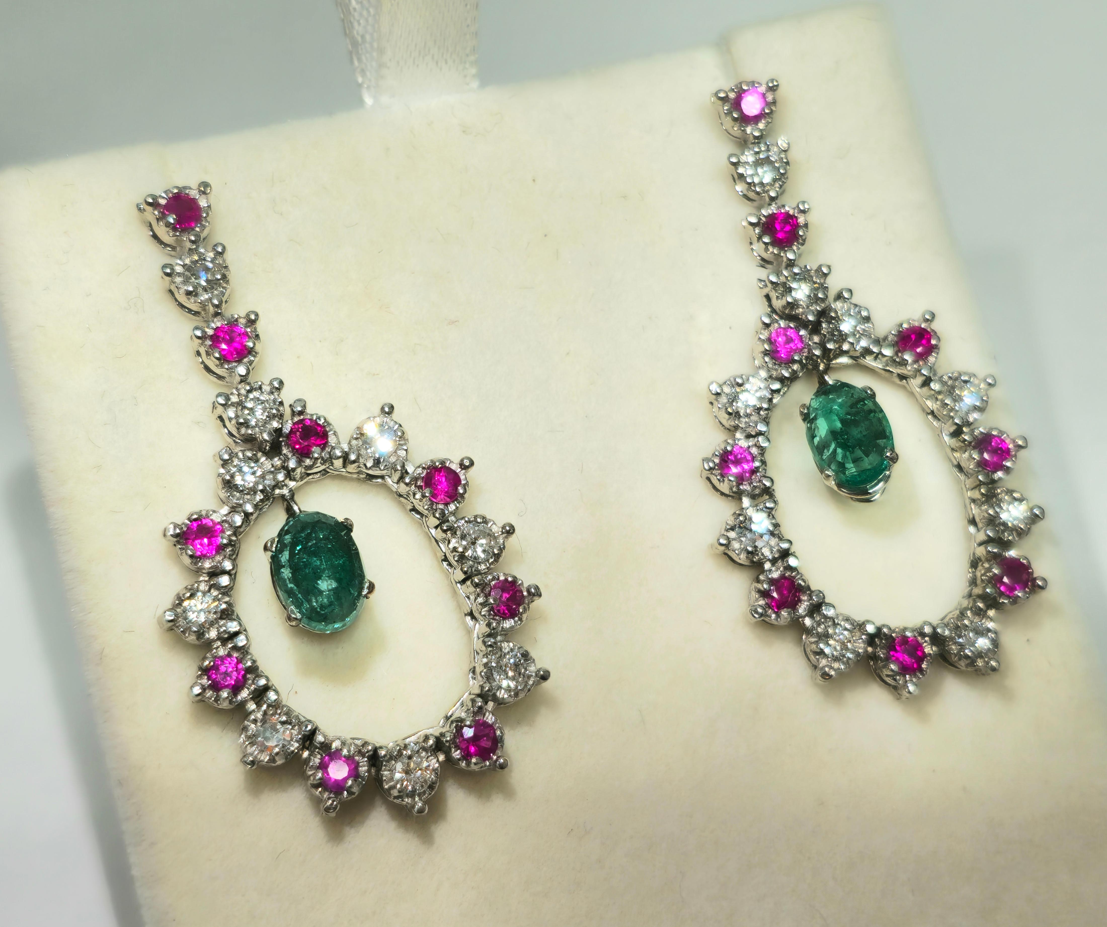 Step into sophistication with our Vintage Style Multi Gemstone Cocktail Earrings, crafted from elegant 14K white gold. Adorned with a stunning 1.00 carat round-cut Burma ruby, a mesmerizing 4.00 carat oval-cut Colombian emerald, and sparkling 1.00
