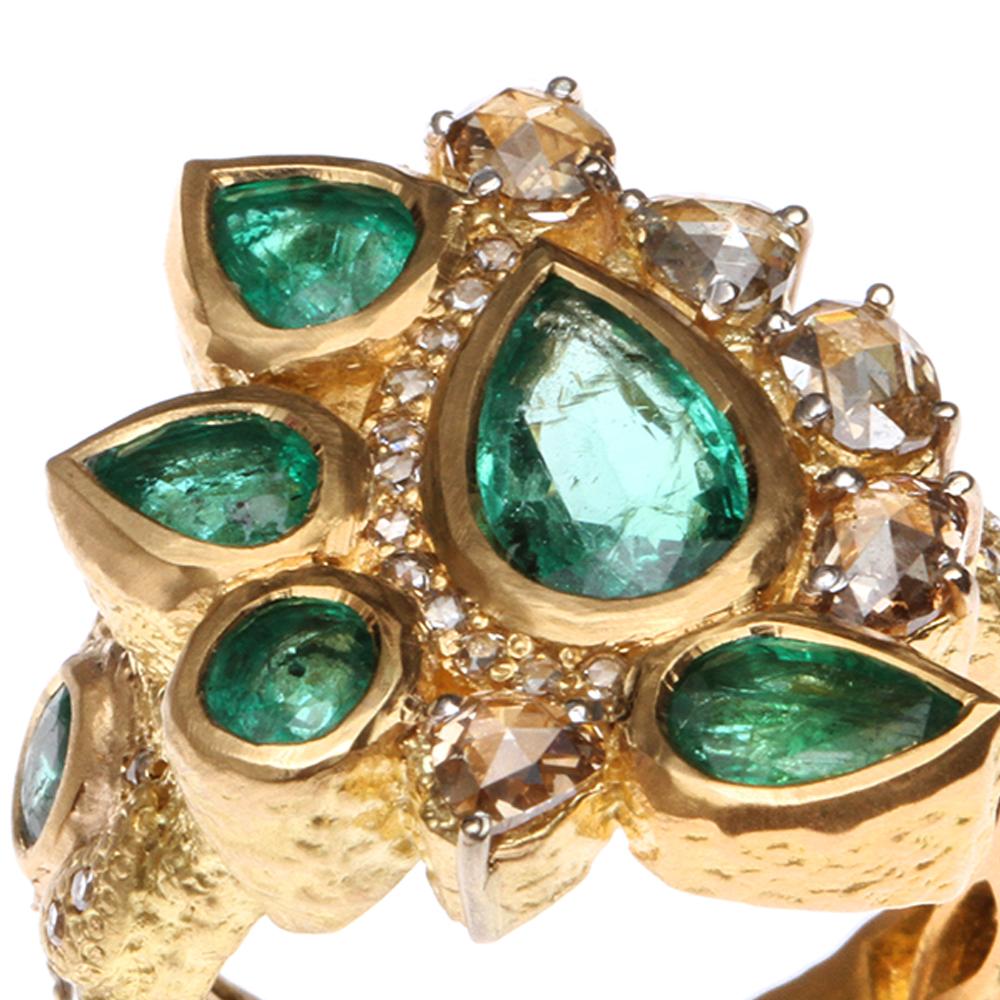 Cocktail Ring set in 20 karat Yellow Gold with 2.29-carat Emerald and 0.93-carat Rose-cut Diamonds. The Emeralds in this ring exhibit a deep green hue and are complemented by Rose-cut Diamonds.