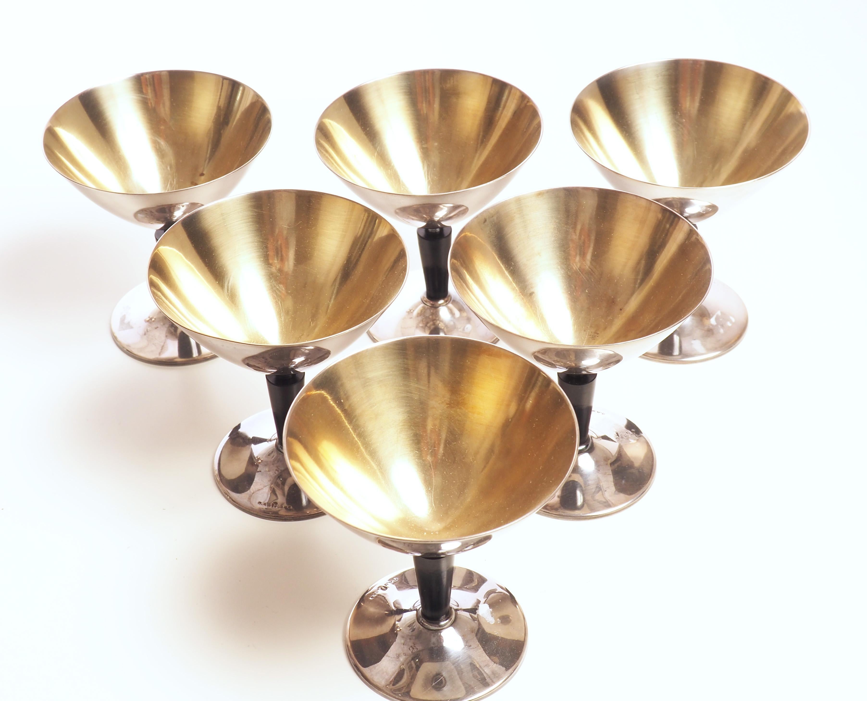 A set of six cocktail glasses in silver plate and bakelite with gilt inside. The glasses were designed by Folke Arström and produced by GAB, Guldsmeds AktieBolaget during the 1930s.

Free shipping worldwide.