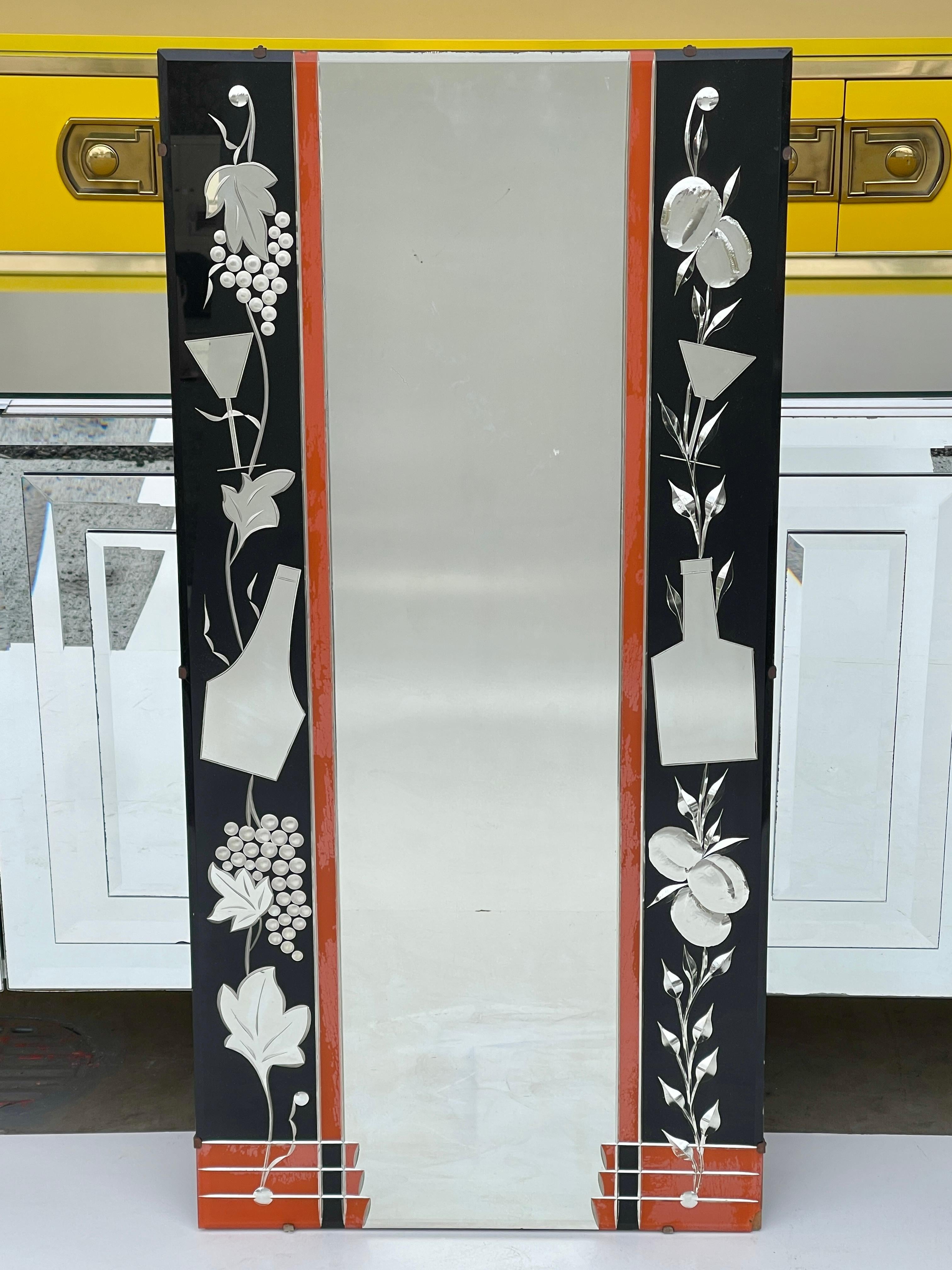 Vintage 1930s Art Deco eglomise wall mirror with wine and spirits motifs. Likely Venetian although possibly English, single half inch glass pane with chamfered edges with central silvered mirror and vertical orange/red and black reverse painted