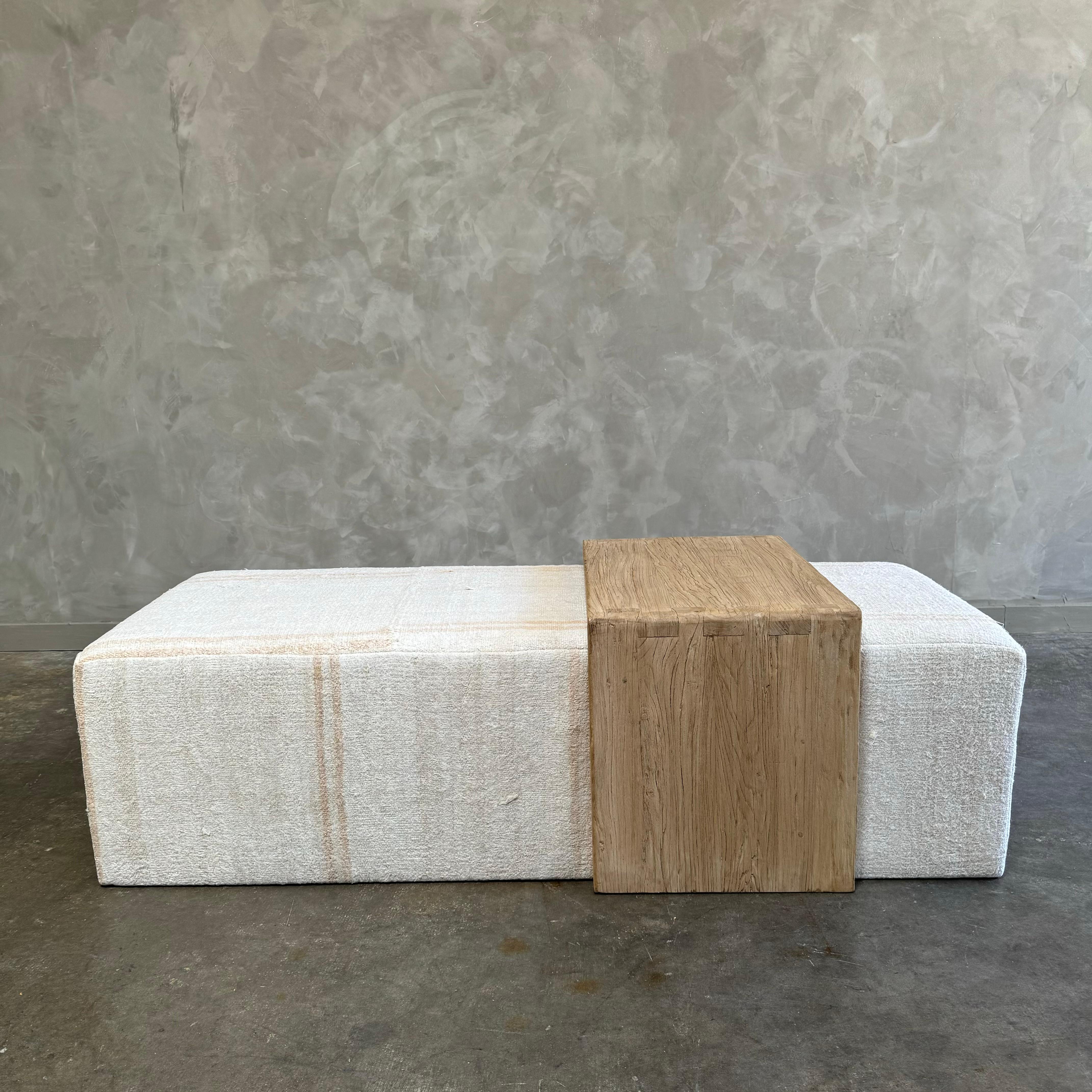 Our cube ottoman is upholstered in a beautiful hemp rug. A light color with flax natural stripes give this a vintage hemp rug ottoman a versatile style. The hand-crafted solid elm wood waterfall table has unique characteristics with beautiful grain