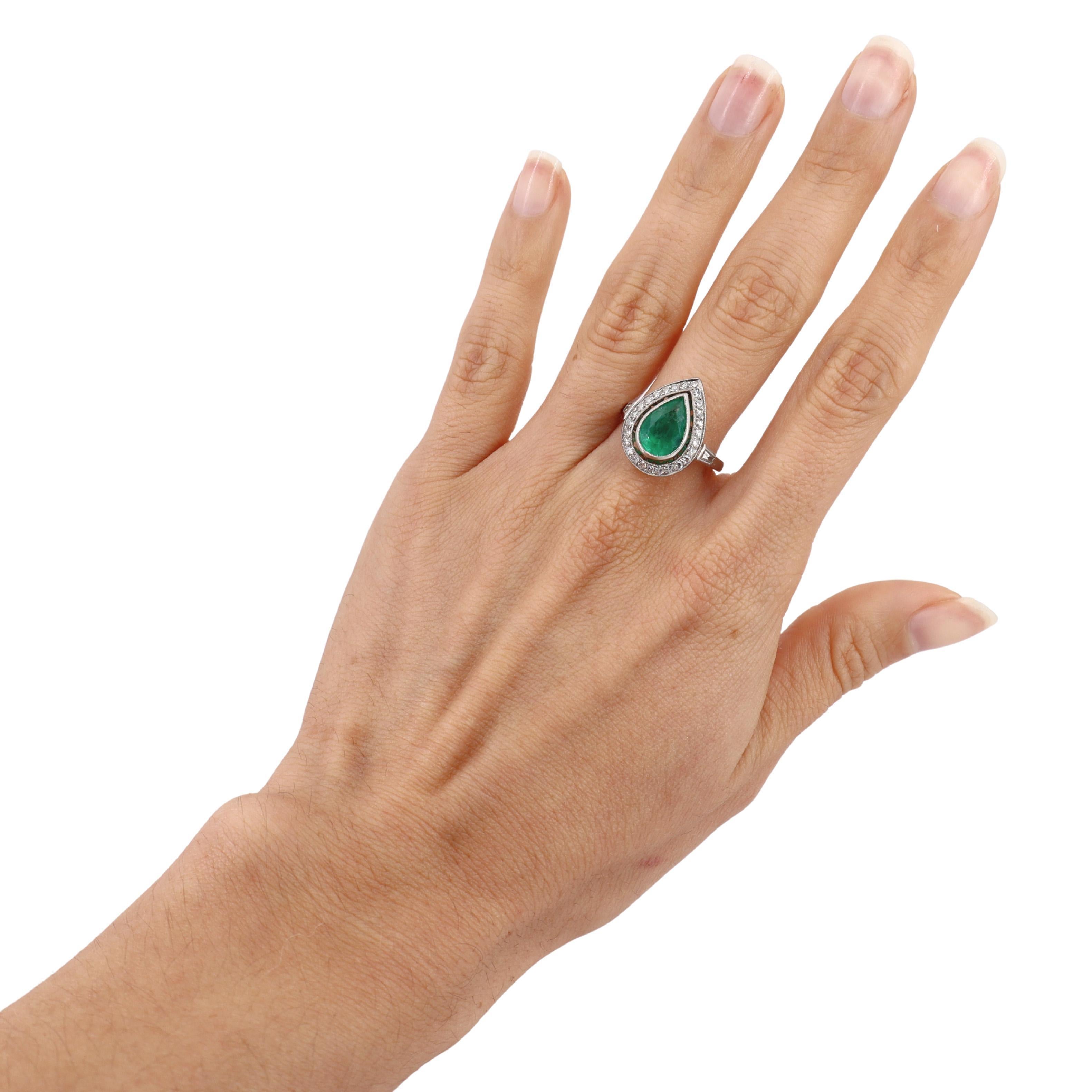 Introducing an exquisite Cocktail Drop Shape Ring, masterfully crafted in platinum, symbolizing elegance and sophistication.At the heart of this stunning piece lies a drop-shaped emerald weighing approximately 2.40 carats, radiating a rich, vibrant