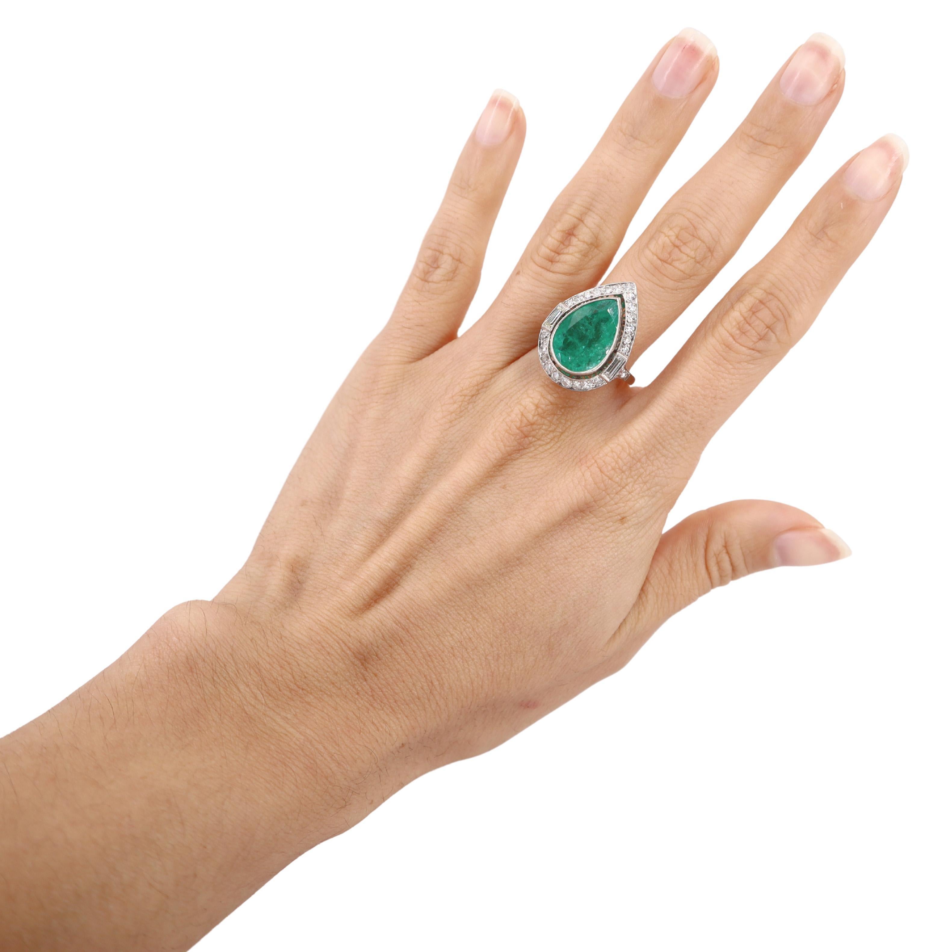 Introducing a stunning Cocktail Drop Shape Ring expertly crafted in platinum, featuring a captivating drop-shaped emerald that weighs approximately 6.00 carats. This exquisite emerald showcases a rich green hue, making it a true centerpiece that