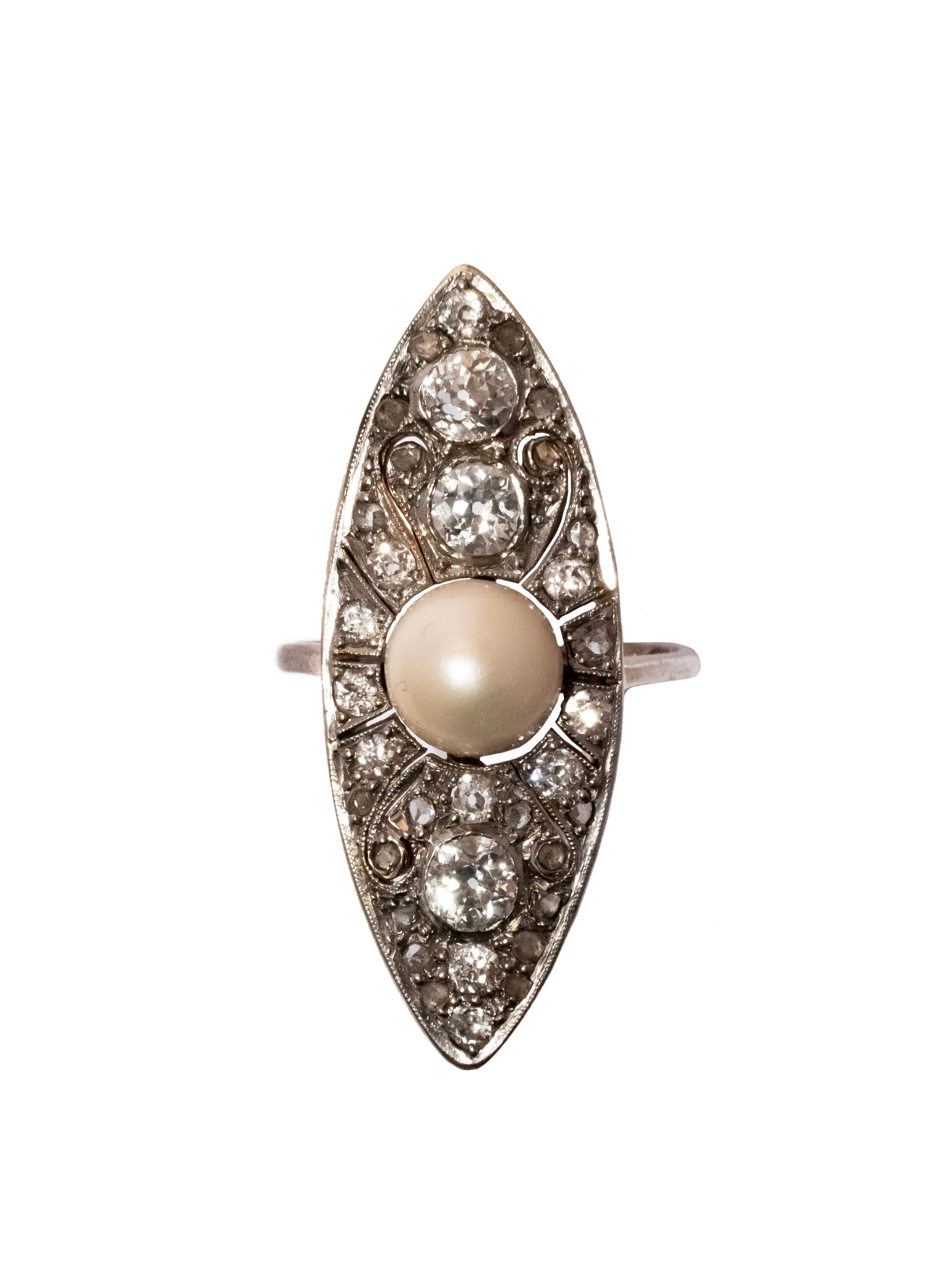 Embrace vintage glamour with this enchanting cocktail ring. Crafted in 18k white gold, it features a beautiful flood pearl center stone surrounded by 1.25 ct old cut diamonds.

This ring is a true testament to the craftsmanship of a bygone era,