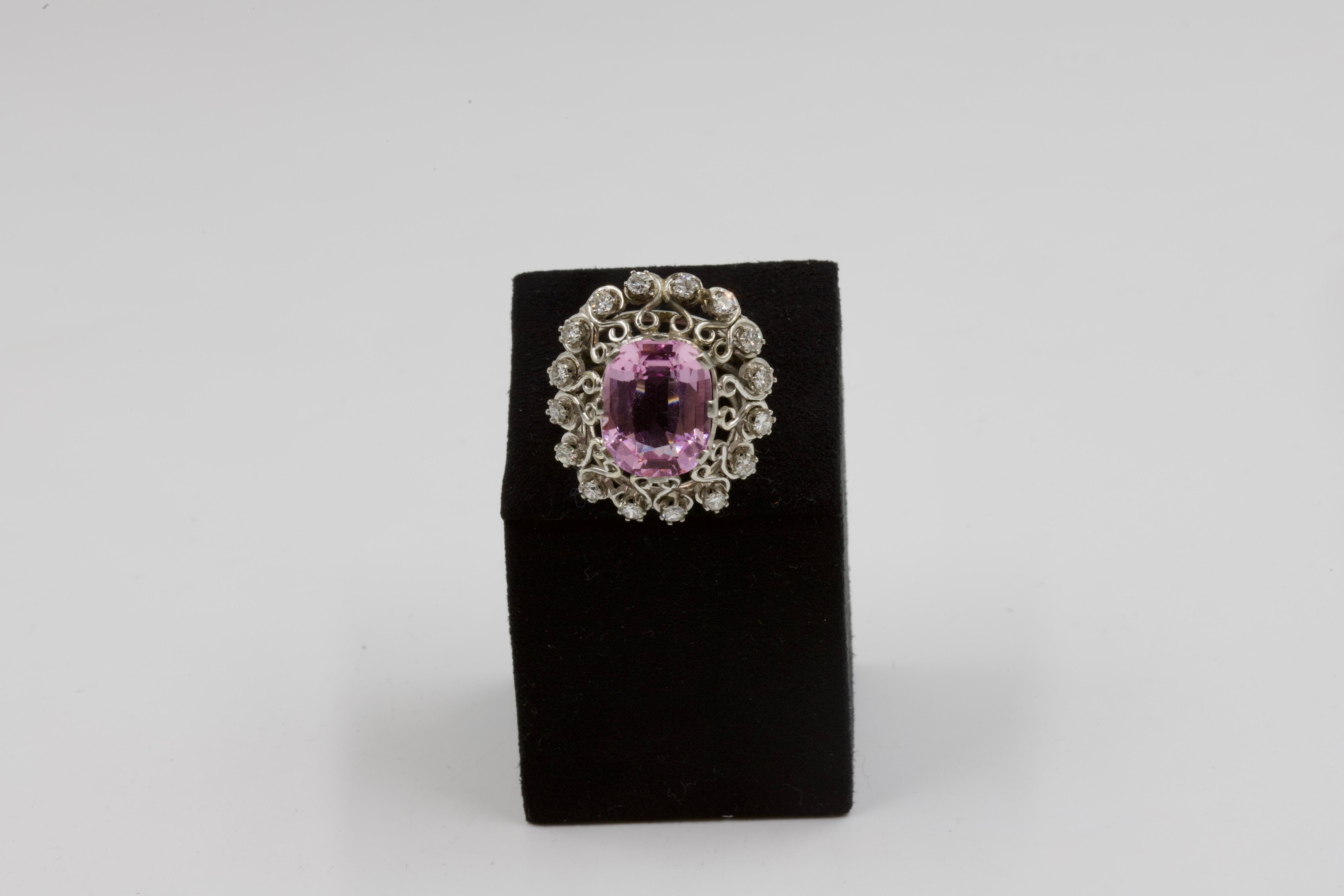 Spectacular cocktail ring, 18 K white gold, centered with a large oval-cut kunzite, openwork surround, filigree with heart motifs, and set with 16 brilliant-cut diamonds, openwork and filigree ring, french work, circa 1960.

For Vintage