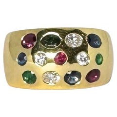 Vintage Cocktail ring made of 18 carat gold with diamonds, rubies, smaragd, sapphire