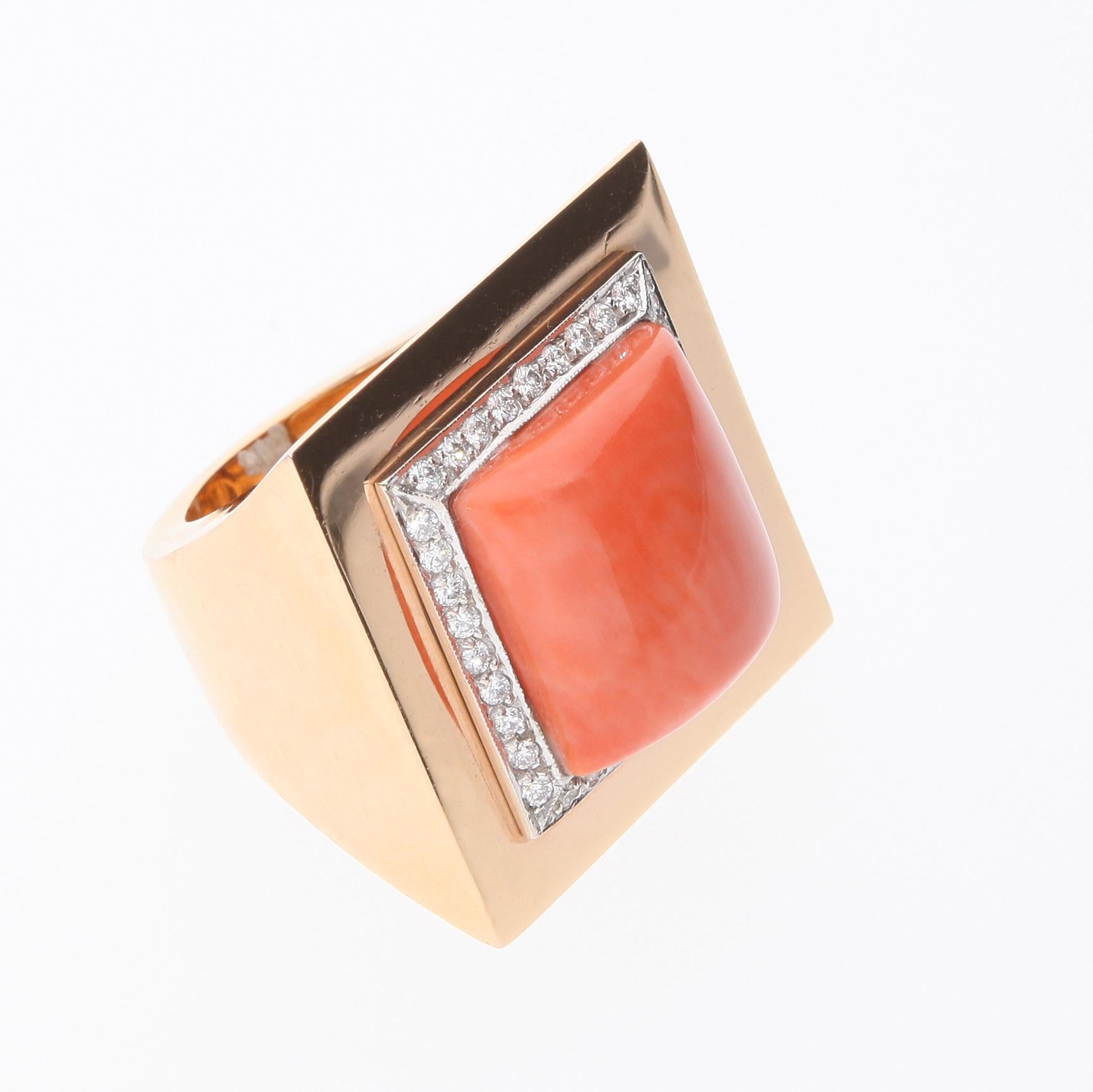 Ring has a natural salmon colored coral, convex shape, fancy cut. 
The coral is surrounded by 36 diamonds set on a white gold rail.
The ring has a spring inside which allows you to easily reduce the size, and therefore also to wear it on fingers of