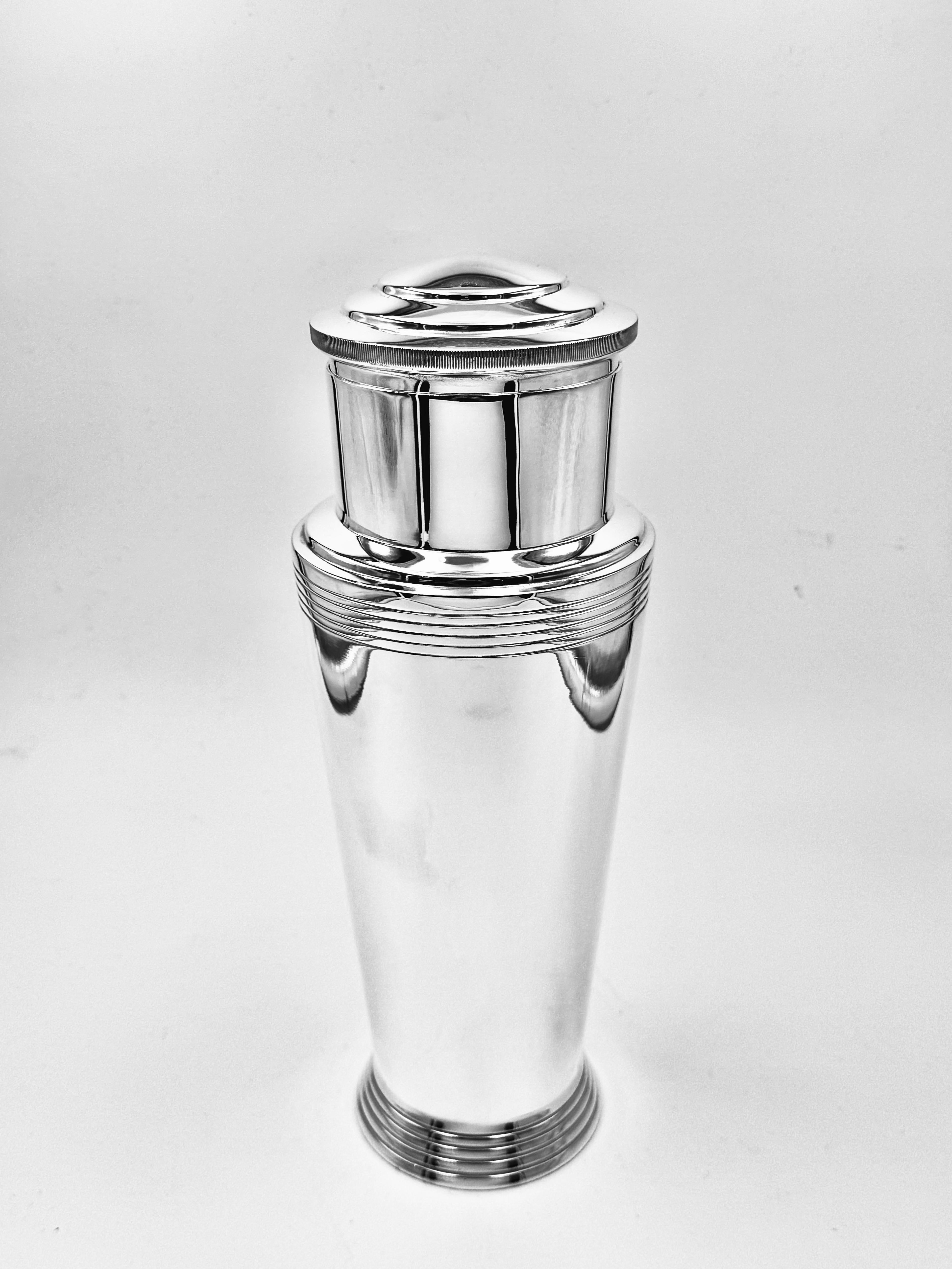 Art Deco silver-plated cocktail shaker, designed by Keith Murray for Mappin & Webb, circa 1935. Of impressive scale and elegant form, with stepped and linear decoration characteristic of Murray’s modernist style. With lift-off cap, removable