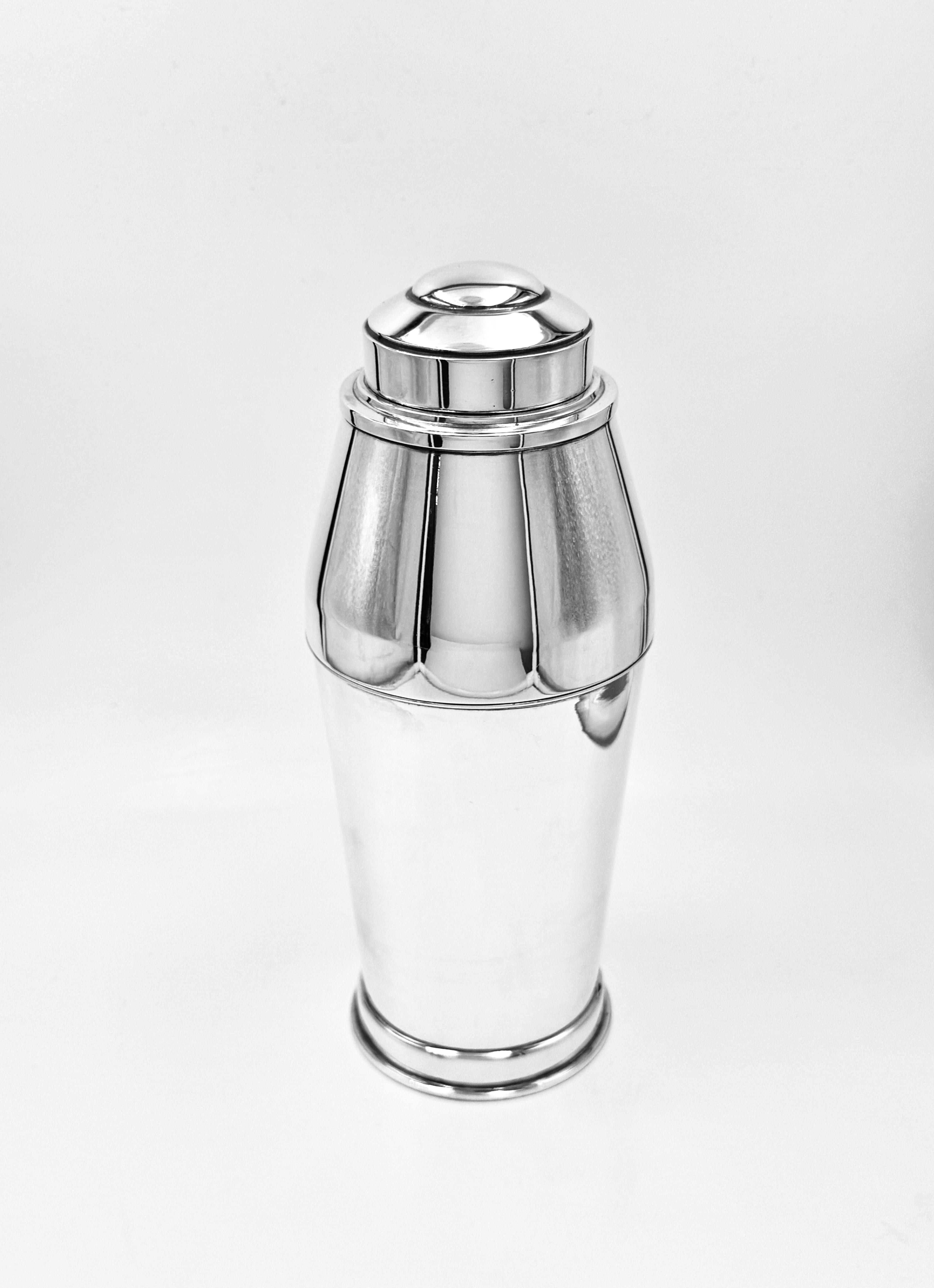 A wonderful English Art Deco Silver Cocktail Shaker made by Walker & Hall in 1954. 
The shaker is exquisitely tapered and will make a good cocktail even better!
A stylish blend of form and function, embodying the timeless elegance of the Art Deco