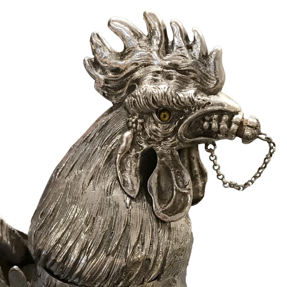 Exceptional large and realistic solid sterling silver cocktail shaker in the form of a rooster. This shaker is finely chiseled with many realistic details. 
The head is enhanced with glass eyes and can be pull-off and the inner part of the shaker.
