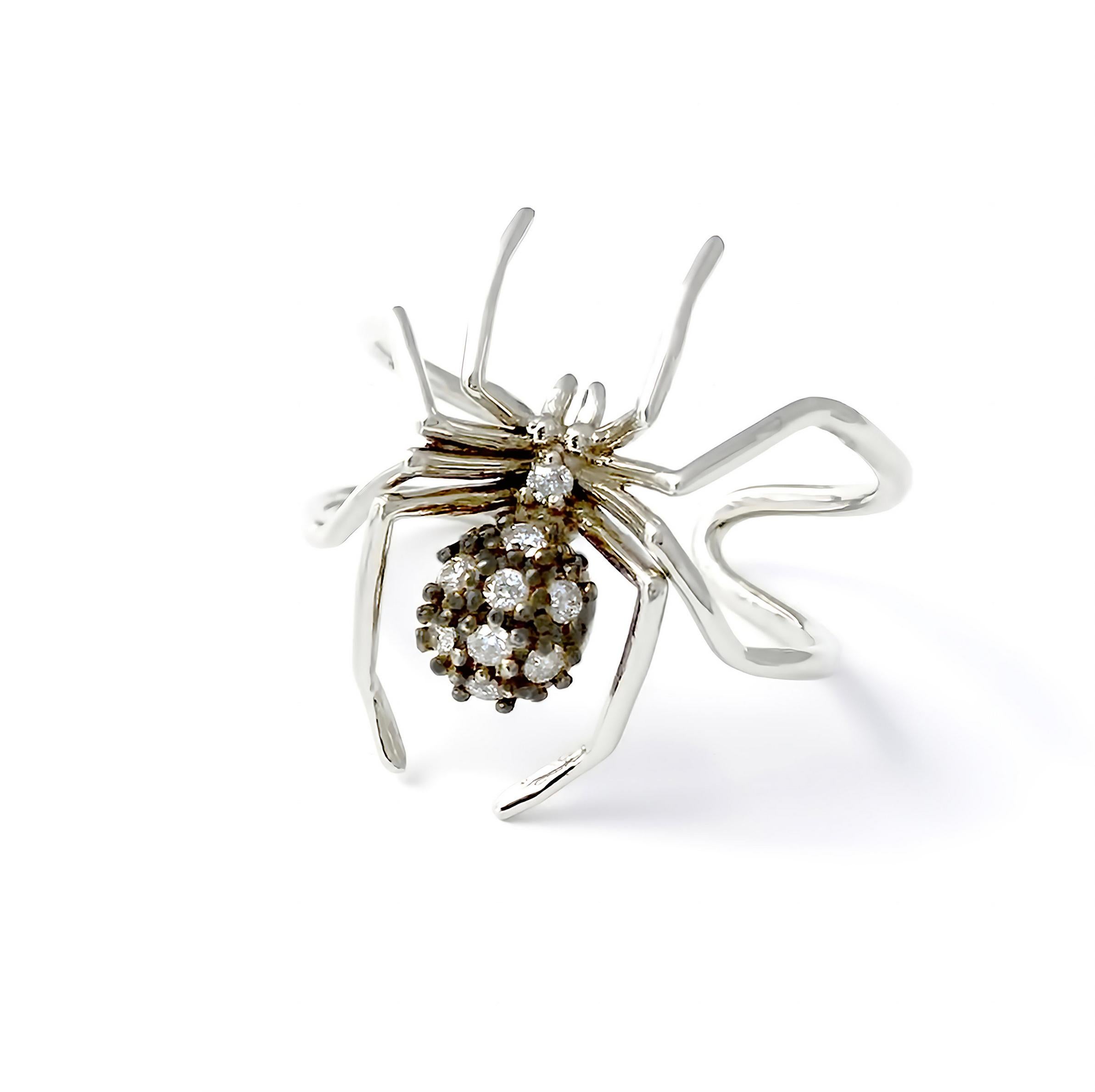 Introducing the exquisite Small Cocktail Spider Ring in White Gold and Black Rhodium, a captivating piece that embodies the spirit of creativity and self-determination. Inspired by the spider, a timeless symbol of ingenuity, this ring showcases the