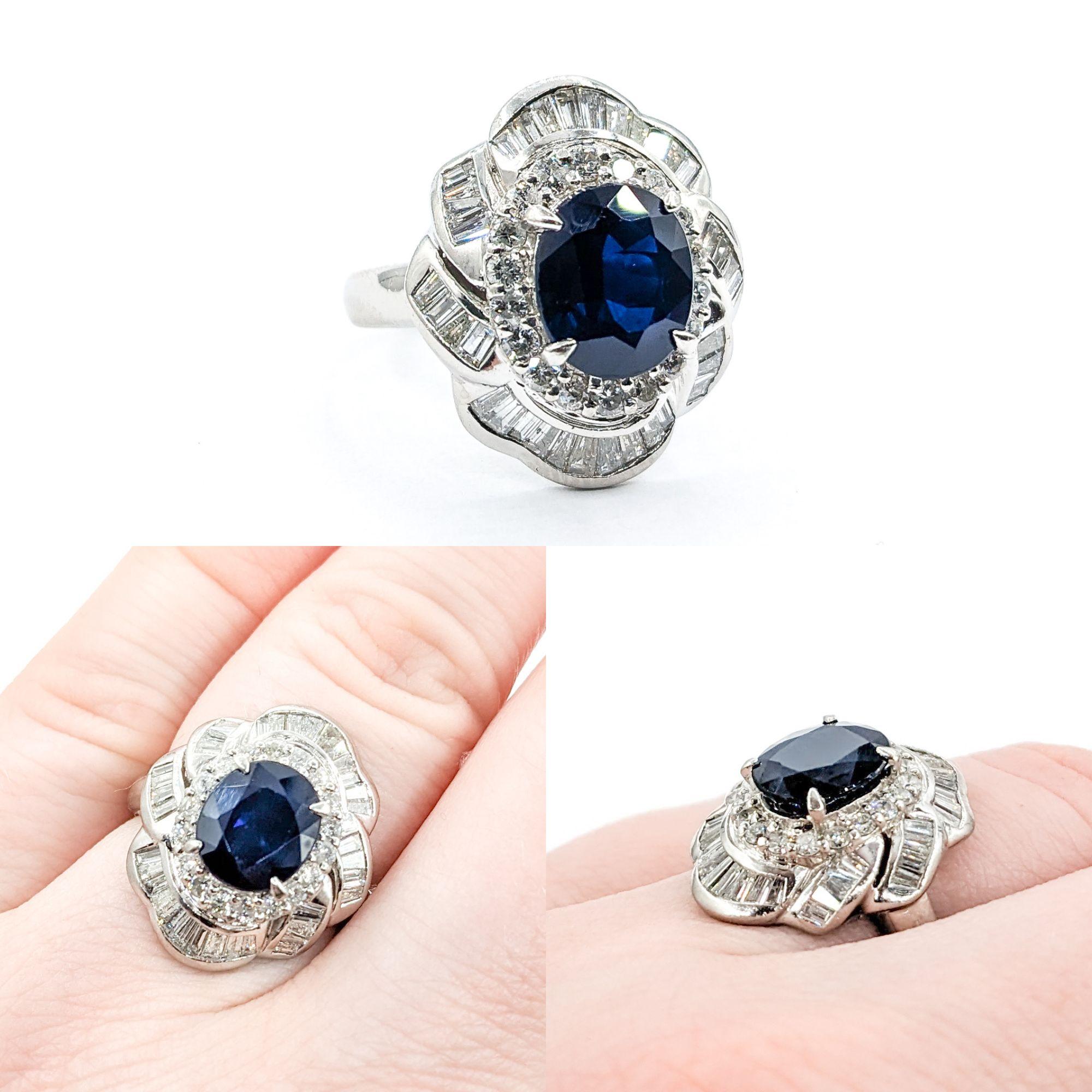 2.83ct Sapphire & 1.21ctw Diamond Halo Cocktail Ring In Platinum

Showcasing an exquisite Sapphire Ring crafted in 900 Platinum, this masterpiece features a stunning 2.83ct Sapphire at its heart, surrounded by 1.21ctw of round & baguette diamonds,