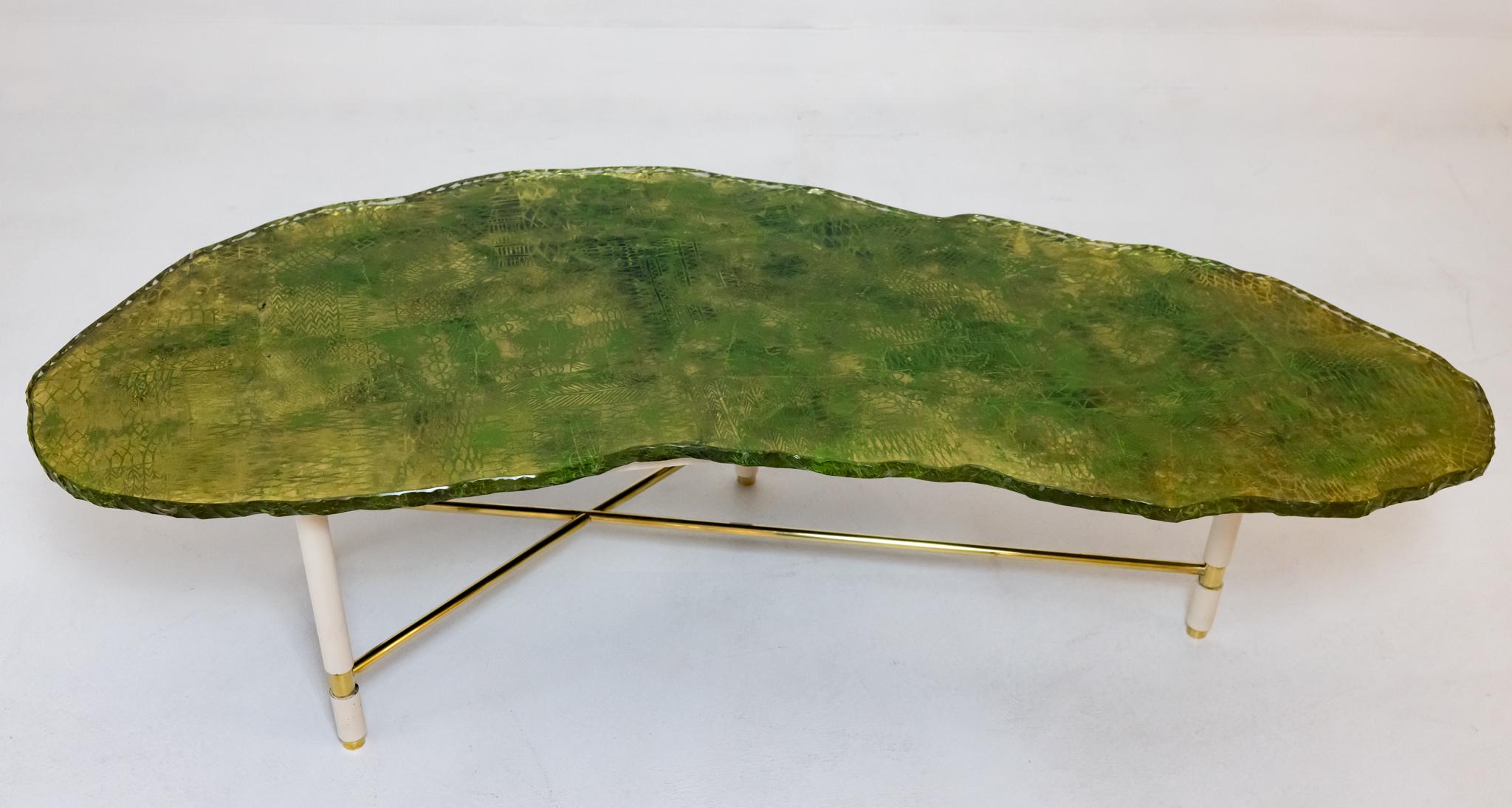 A rare find. This table with original Brass and painted wood base, was produced by Fontana Arte around 1953 in Italy. The table features a free form glass top with a chipped edge. The glass has been painted by Dulio Barnabe under the name Dubè. Dubè
