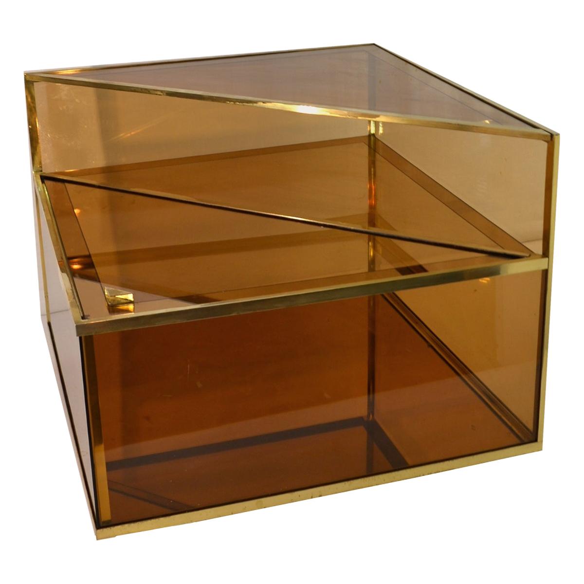 Elegant square vintage end table in three levels in brass with mirror glass and amber colored glass. The base level is made as a dry bar for bottles etc. which opens diagonally from the top. You could also have this in a shop display for instance.