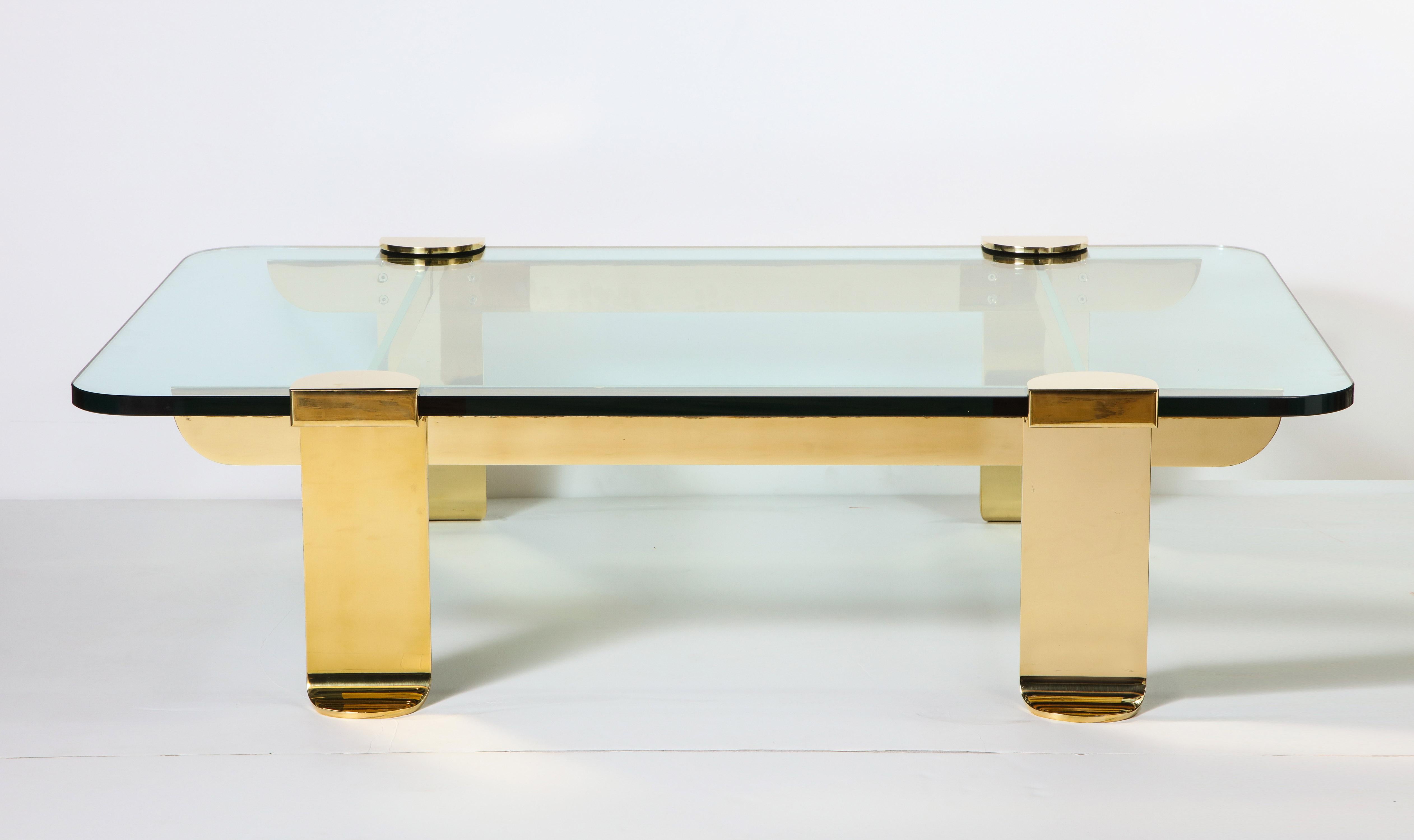 Italian designed, brass and glass sculpture cocktail table, circa 1960. The brass is in very good condition. The glass has some wear consistent with age and use.