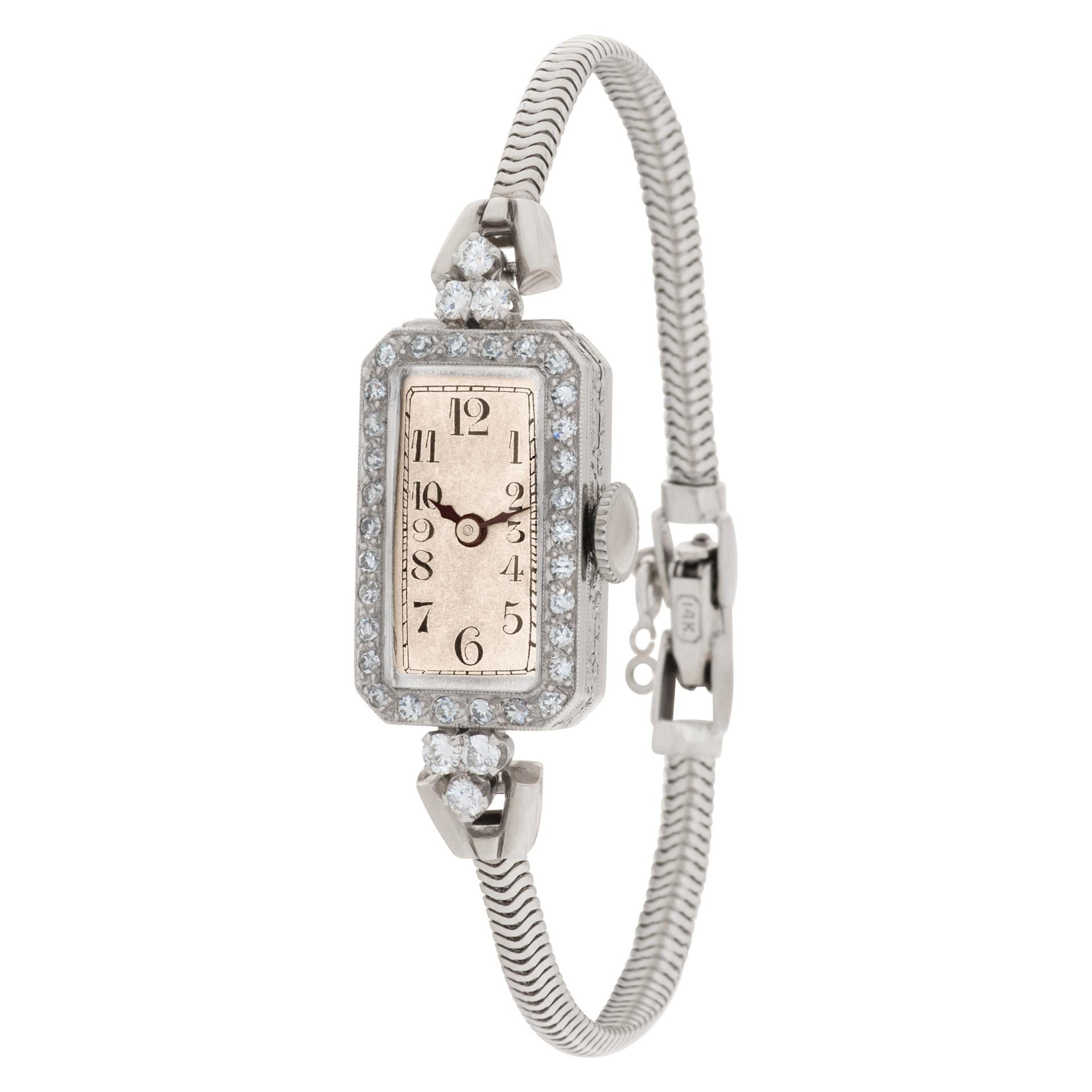 Vintage platinum diamond cocktail watch on a 14k white gold band. Length: 6 inches.
