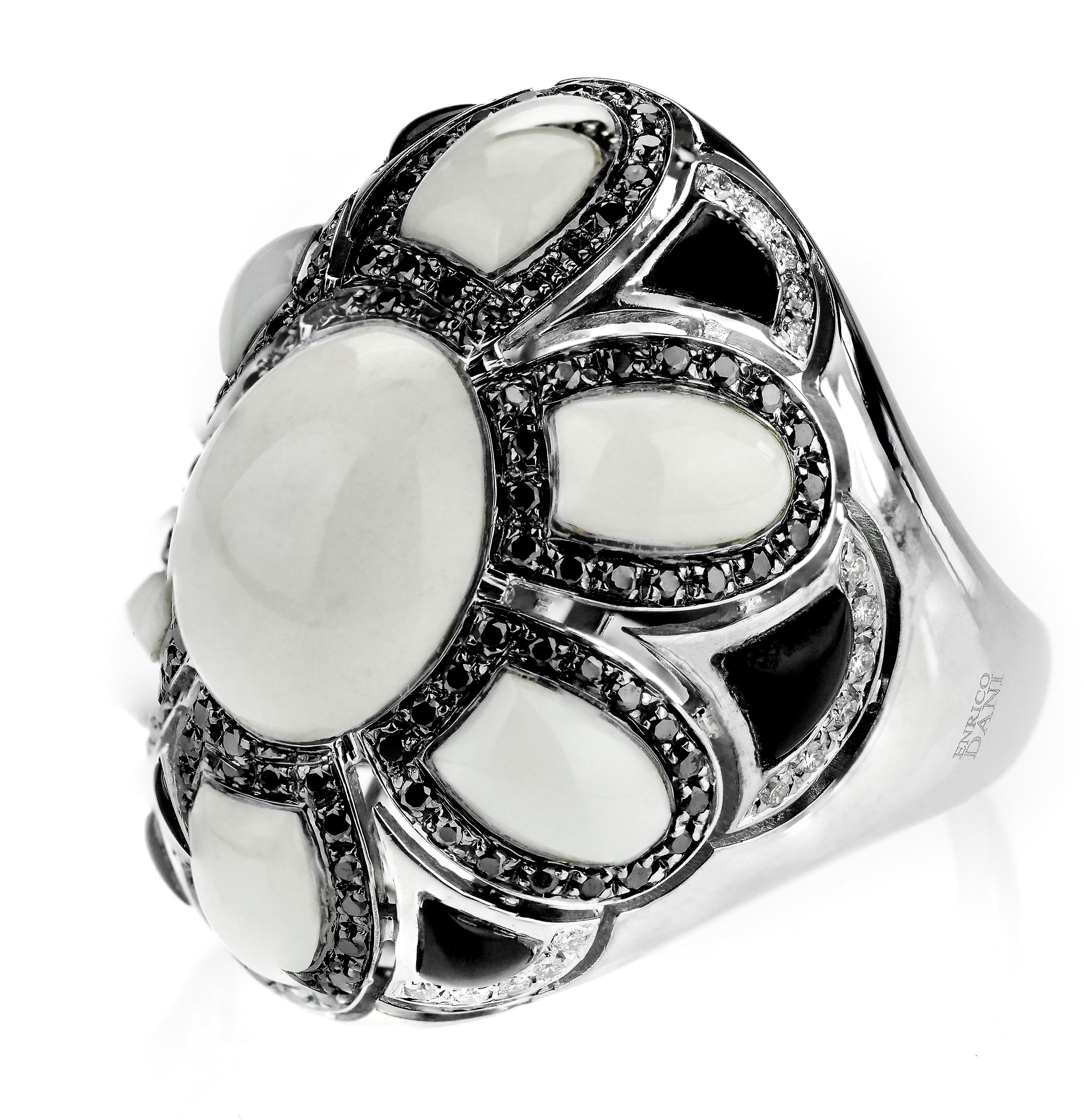 Beautiful black and white cluster ring in a flower motif created from fine white chalcedony and black onyx where the petals and centre cabochons are in white contrast to the black petals in between which diamonds weave in and out. The ring is a bold