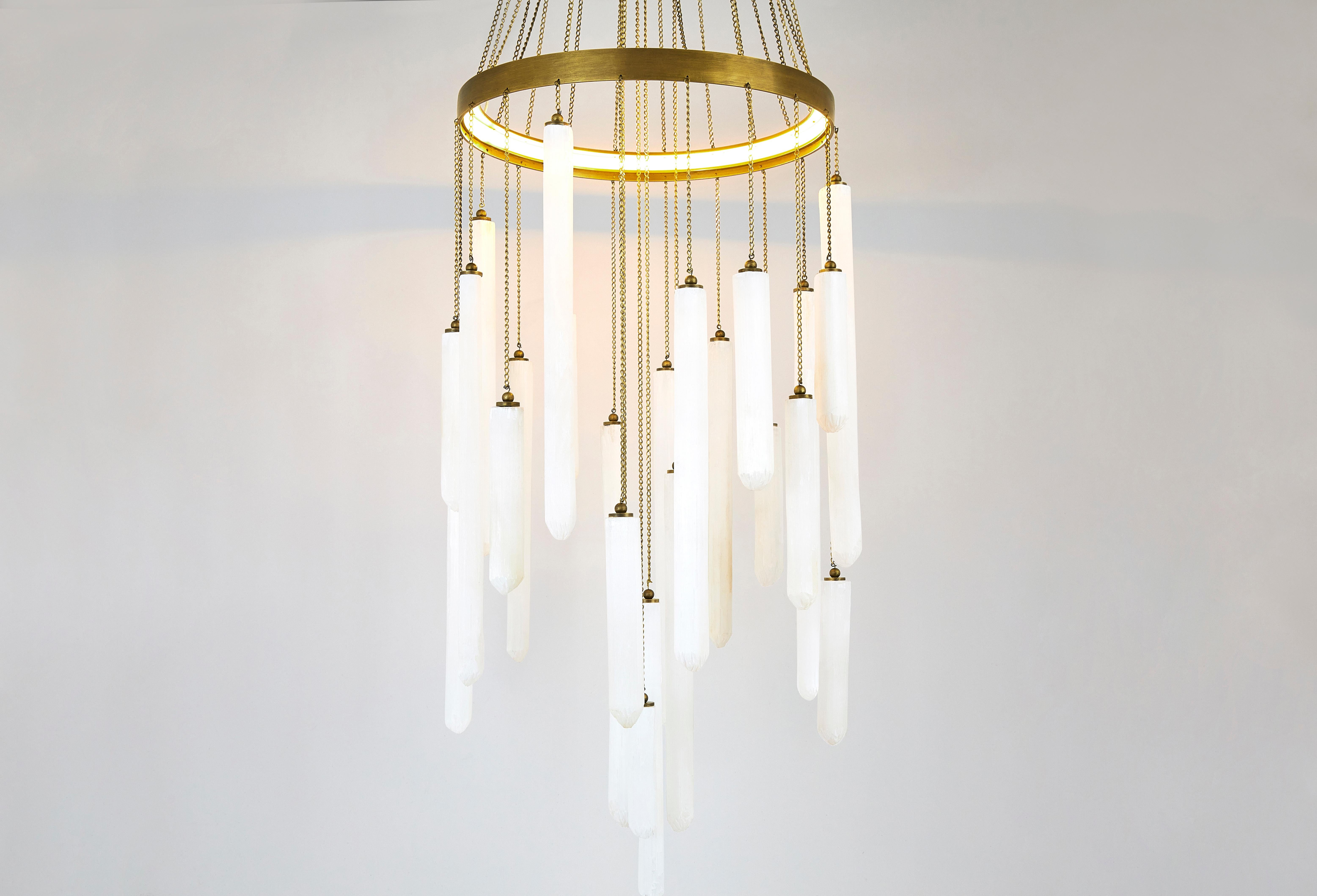 Our Coco Chain Pendant – available in multiple tiers – was created with a nod to Coco Chanel as we use the same chain as the iconic Chanel handbag. With beautiful hanging rock crystal rods cascading from delicate chains suspended by a circular, lit