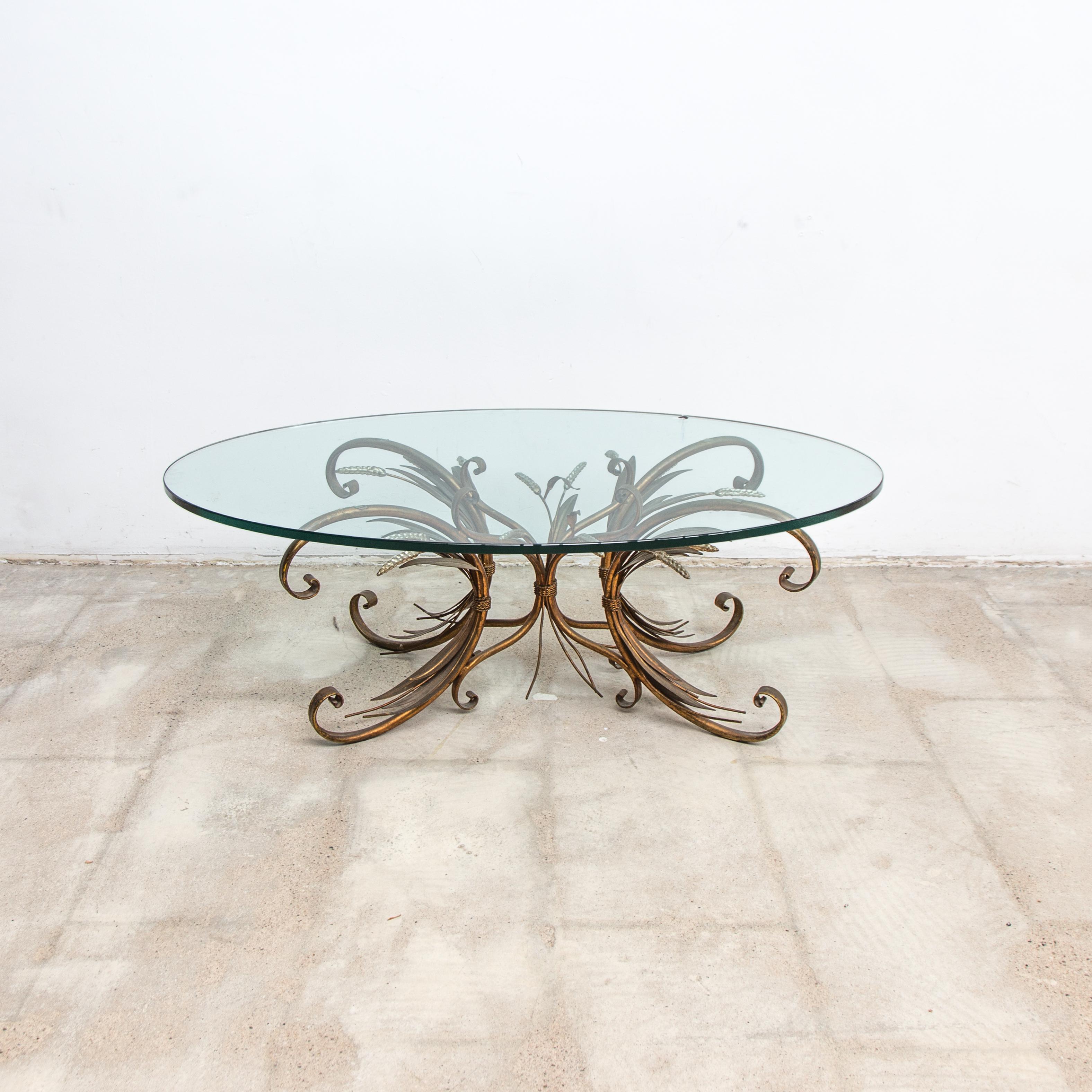 Coco Chanel French coffee table, sheaf of wheat with rare oval glass, 1950s. This wheat sheaf side or table is decorative and has a French origin. The frame holds a patina to the brass surface and the silver finished wheat tops. The table comes with