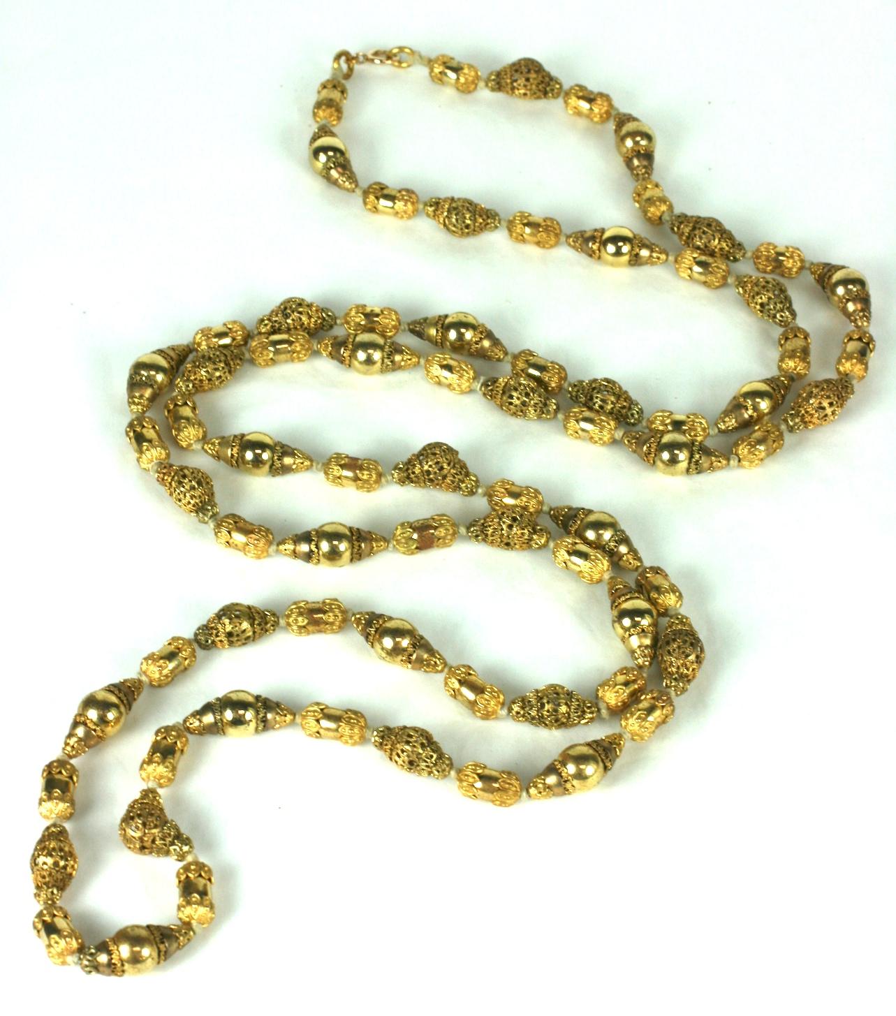 Coco Chanel Gilt Filigree Bead Long Necklace, Goossens. Long chain with gilt filigrees stacked and layered with polished gilt beads. A subtle play on matte and shiny in a long, transformable hand knotted bead necklace. 56