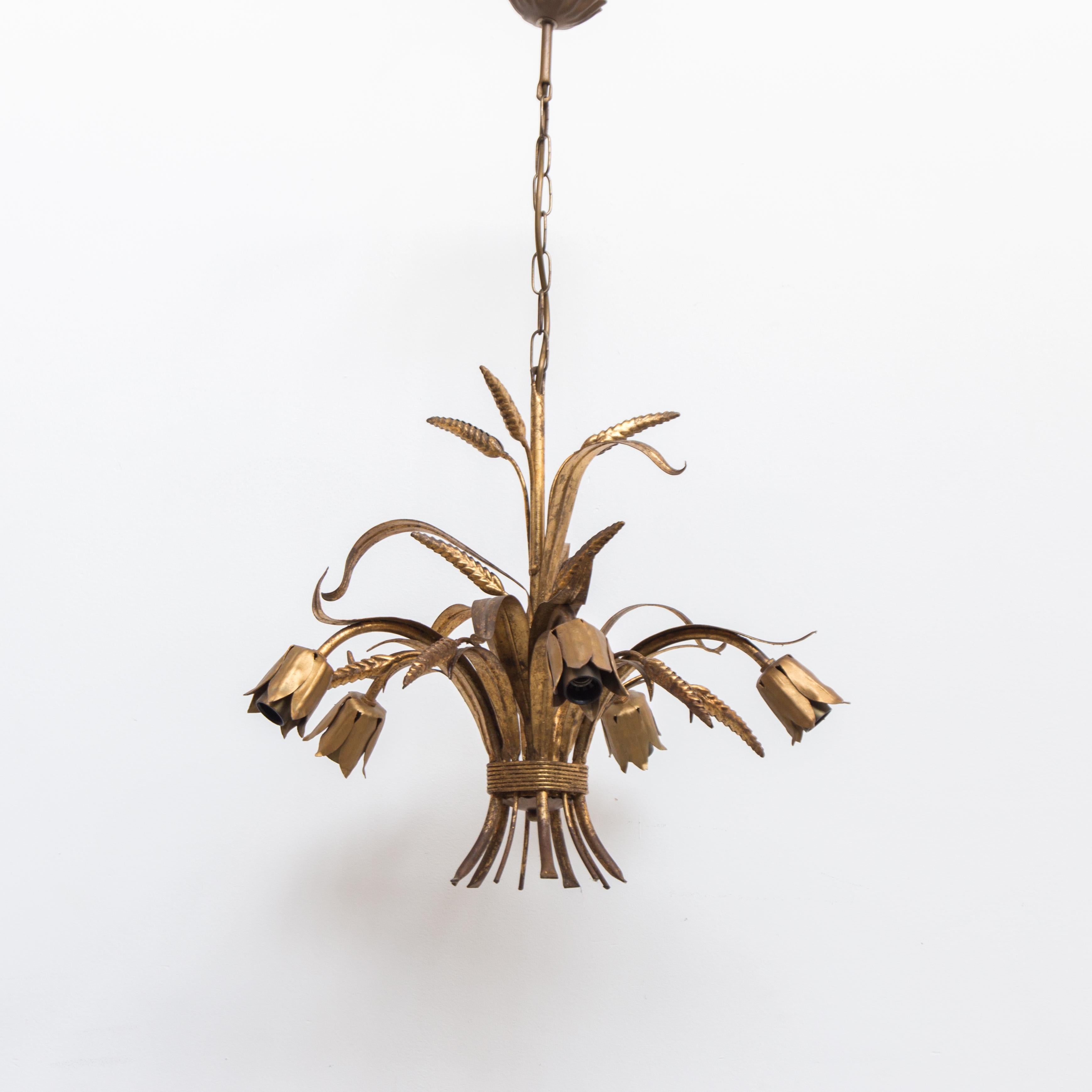 Coco Chanel sheaf of wheat chandelier this pendant light is plated with gold leaf and decorated with wheat leaves the five arms and rare up side down arms are perfectly cited for e10 flame bulbs. This pendant light has a warm antique gold finish.